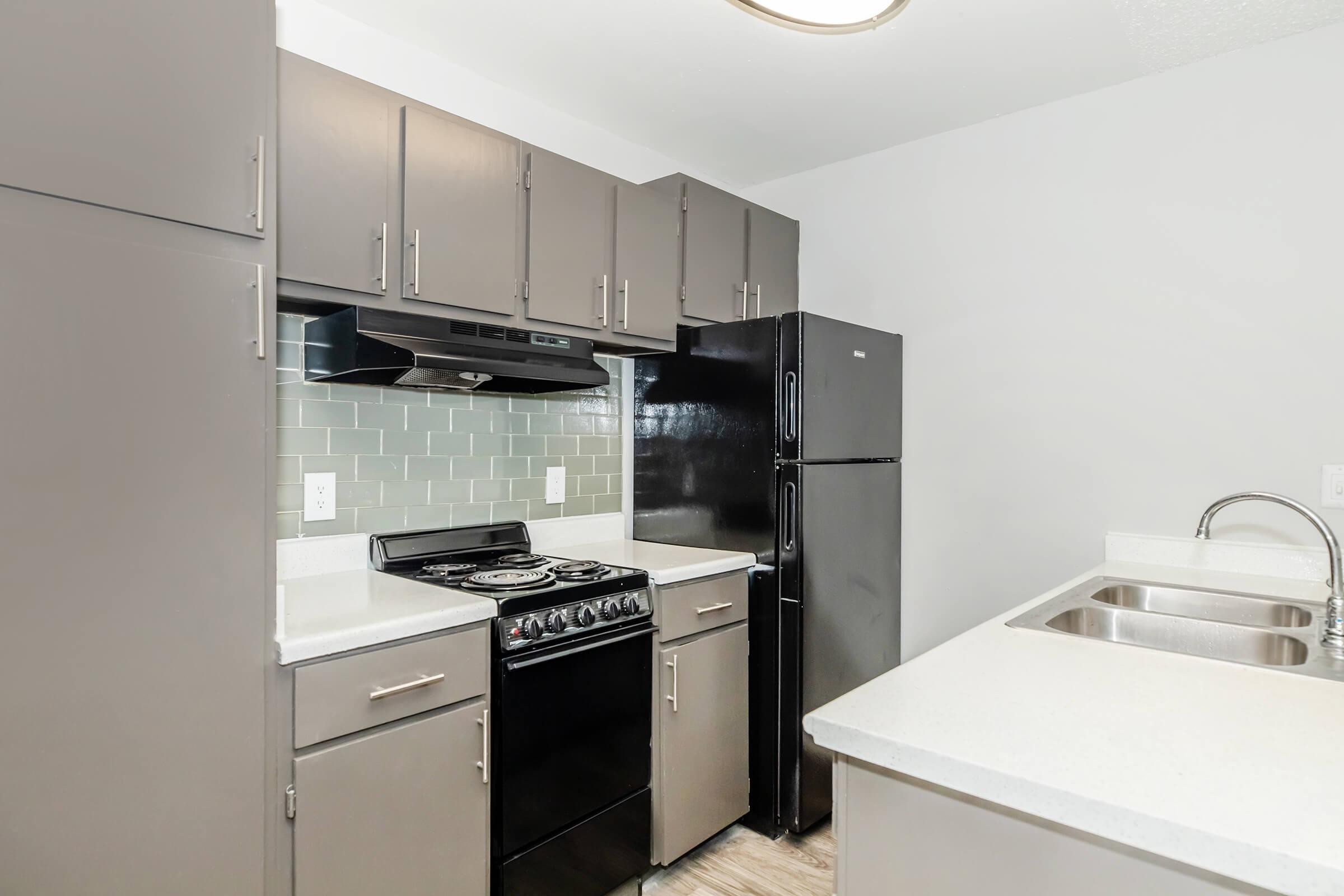 a kitchen with a sink and a refrigerator