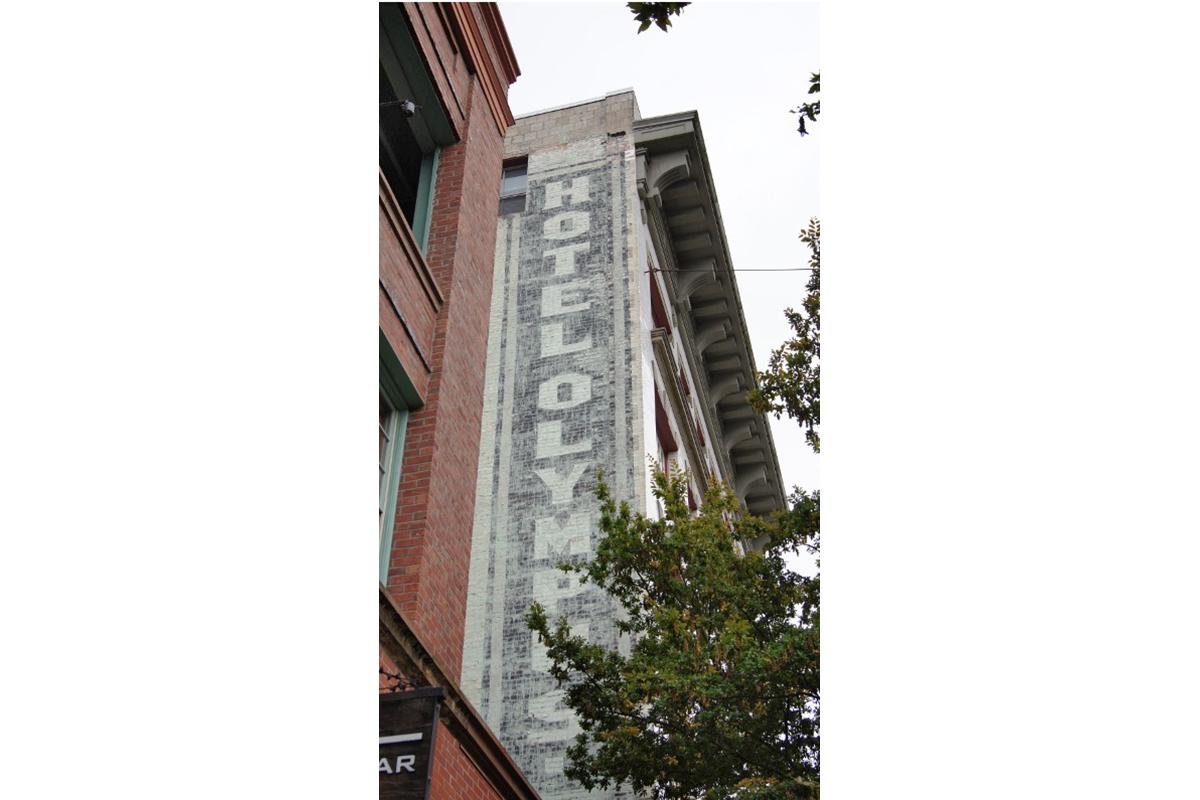 a tall brick tower with a clock on the side of a building