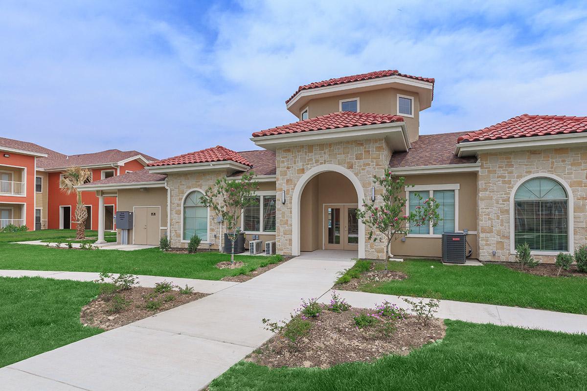 a large lawn in front of a brick building