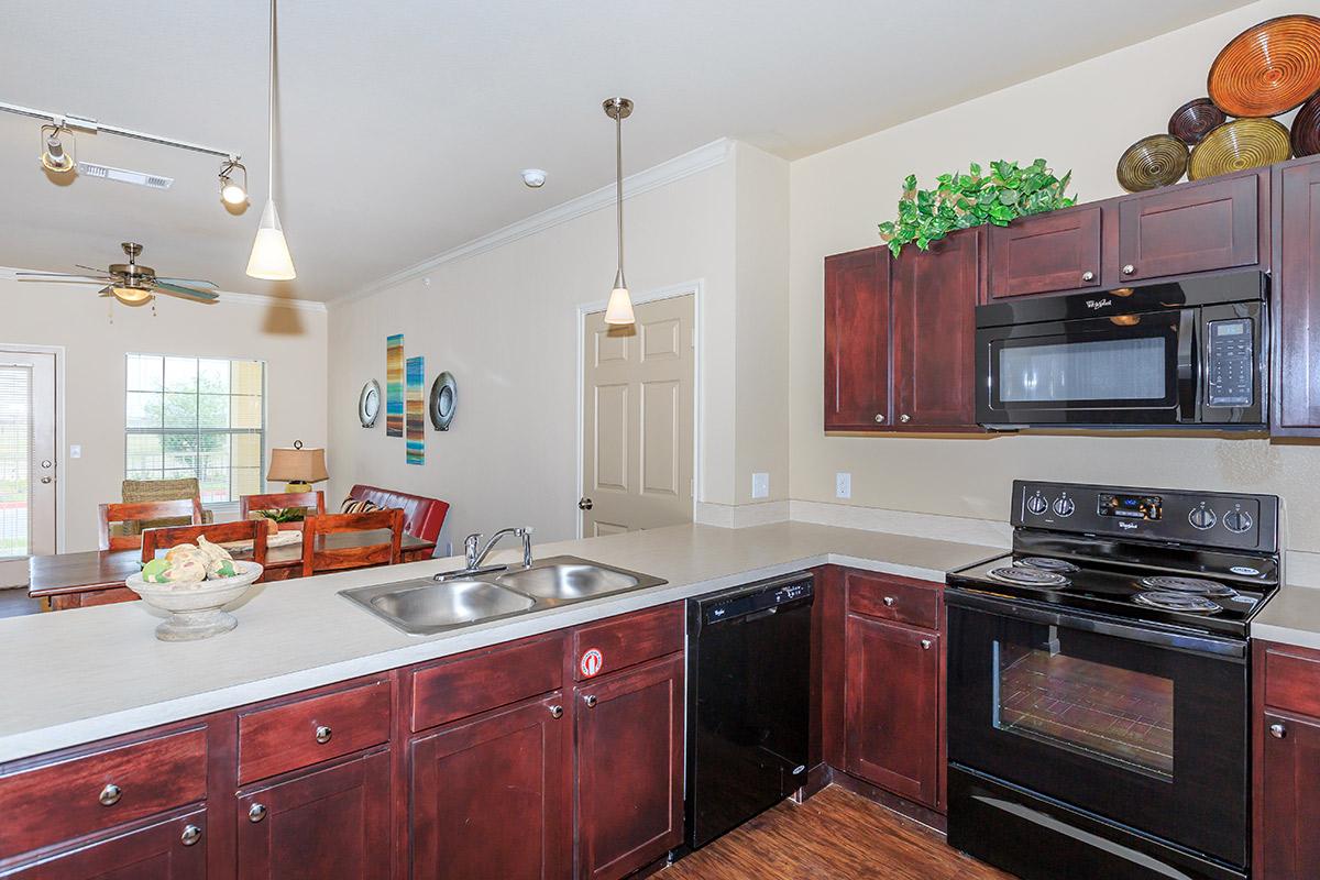 a kitchen with stainless steel appliances and wooden cabinets