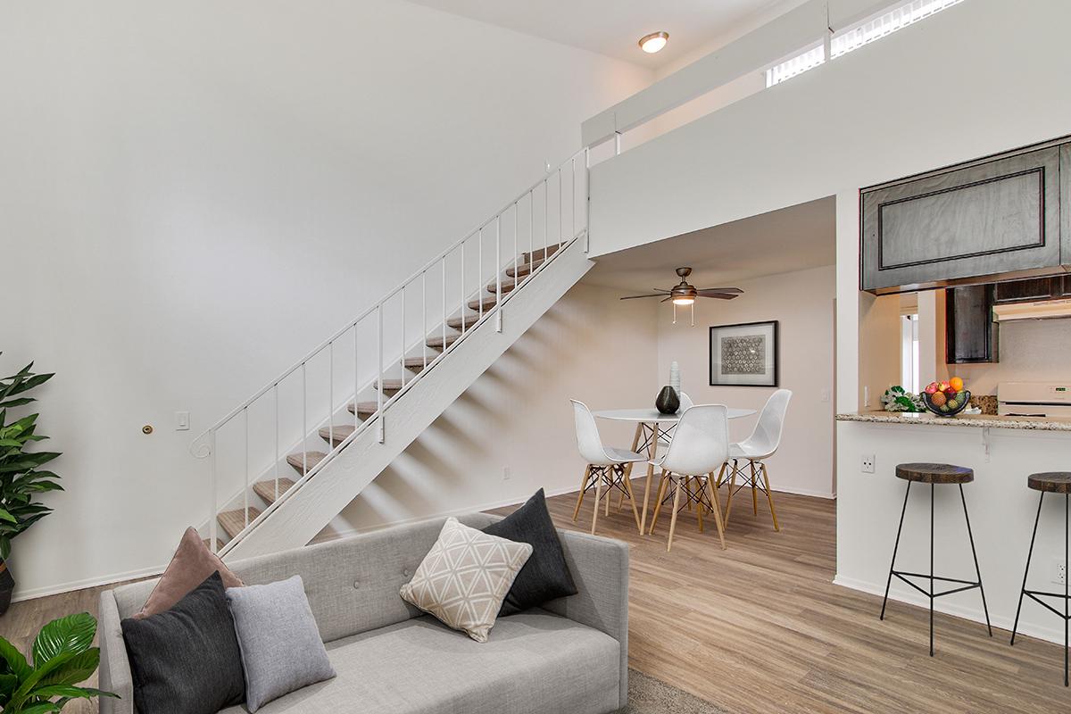 a living room filled with furniture and a large window