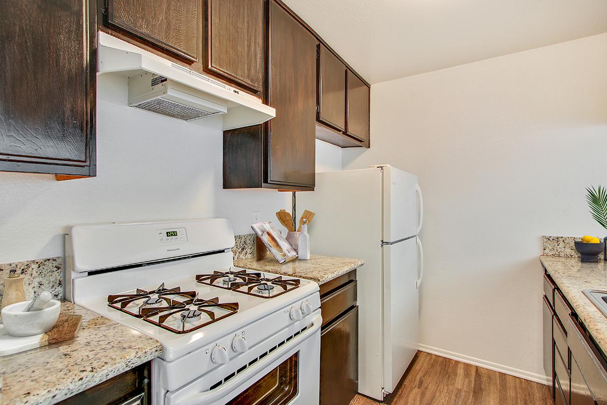 a stove top oven sitting inside of a kitchen