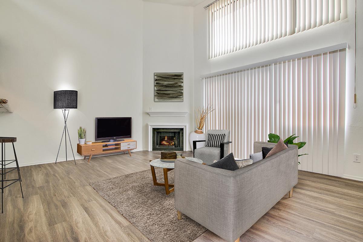 a living room filled with furniture and a large window