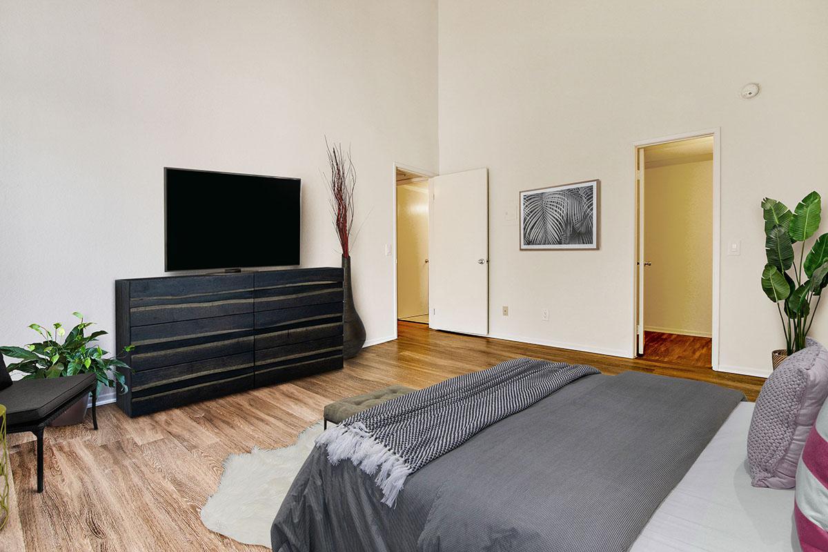 a living room filled with furniture and a flat screen tv