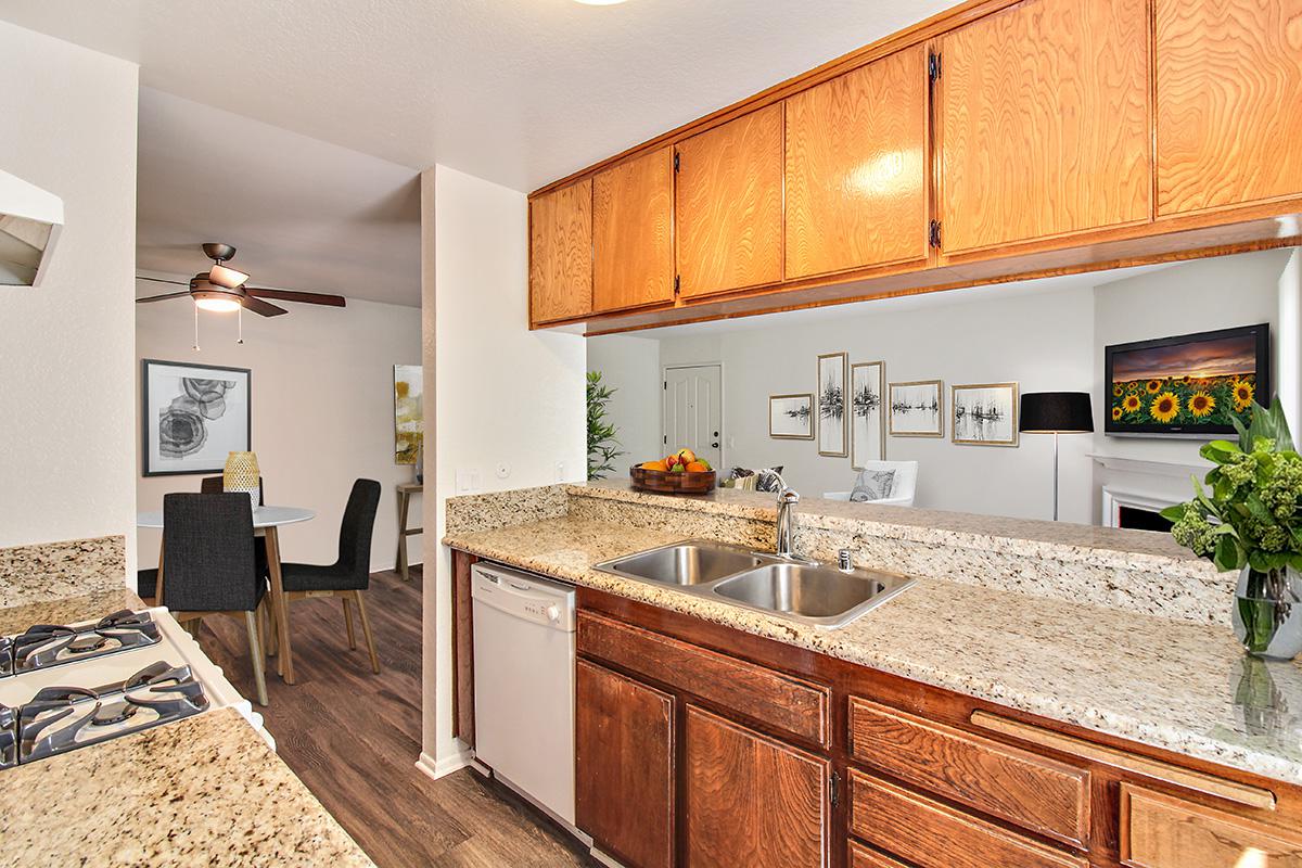 a modern kitchen with stainless steel appliances and wooden cabinets