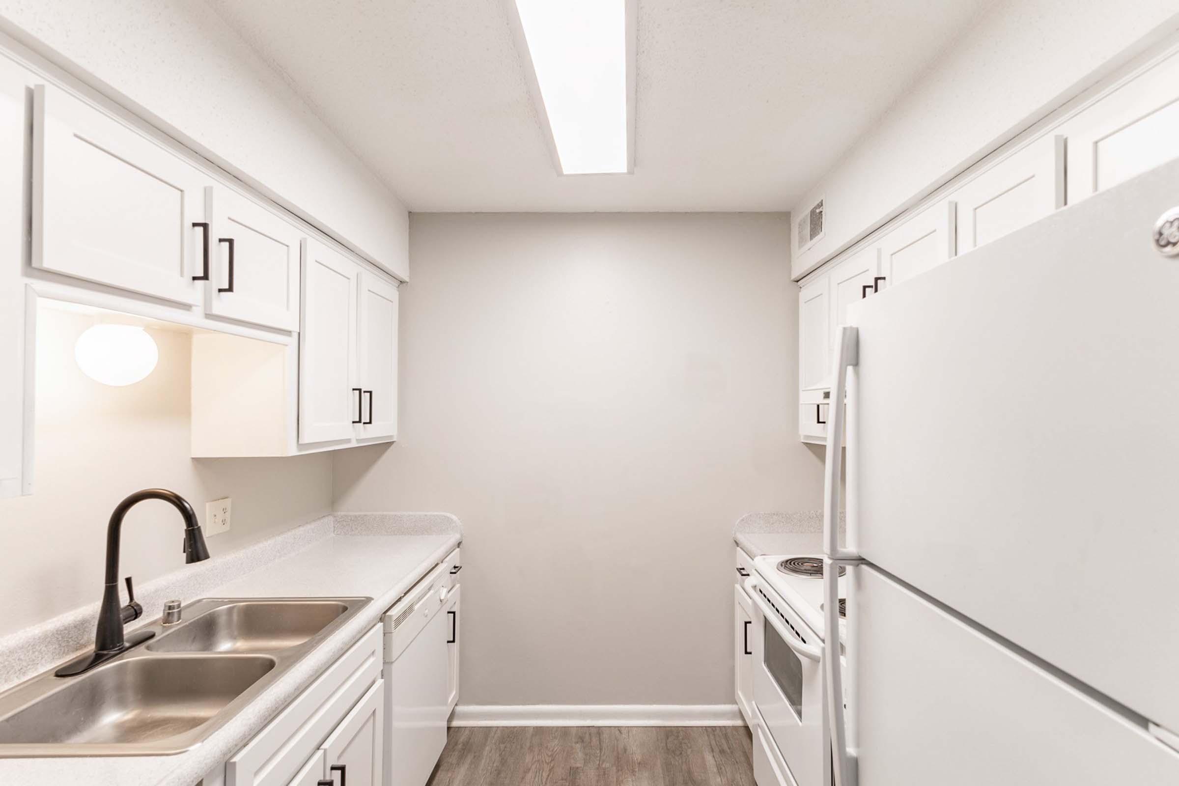 a kitchen with a sink and a refrigerator