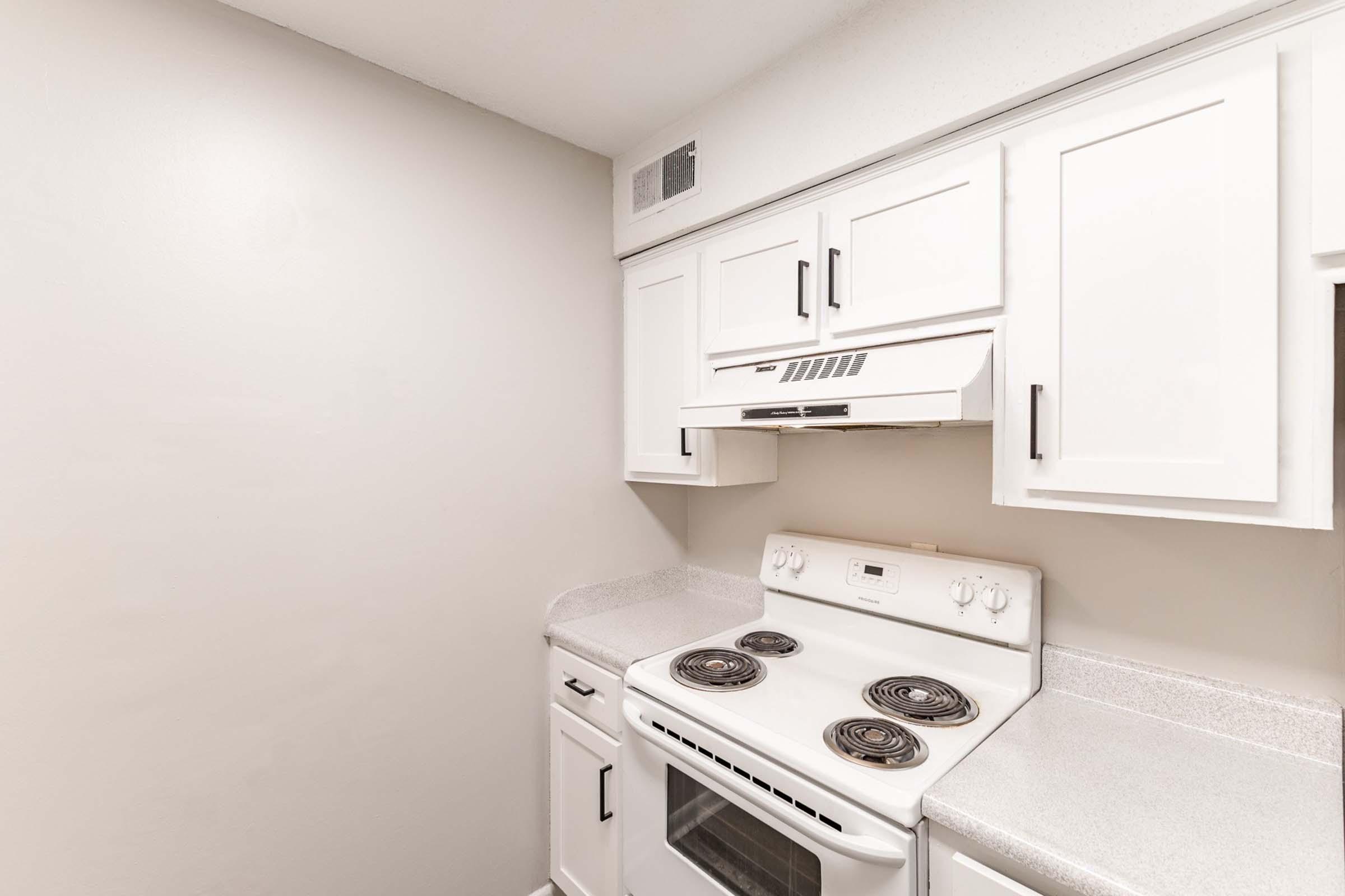 a stove top oven sitting inside of a kitchen