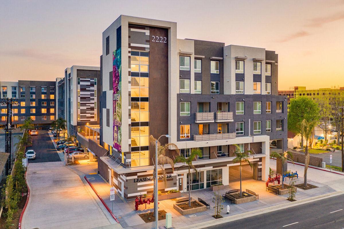 Modern multi-story building featuring contemporary architecture with a colorful mural.