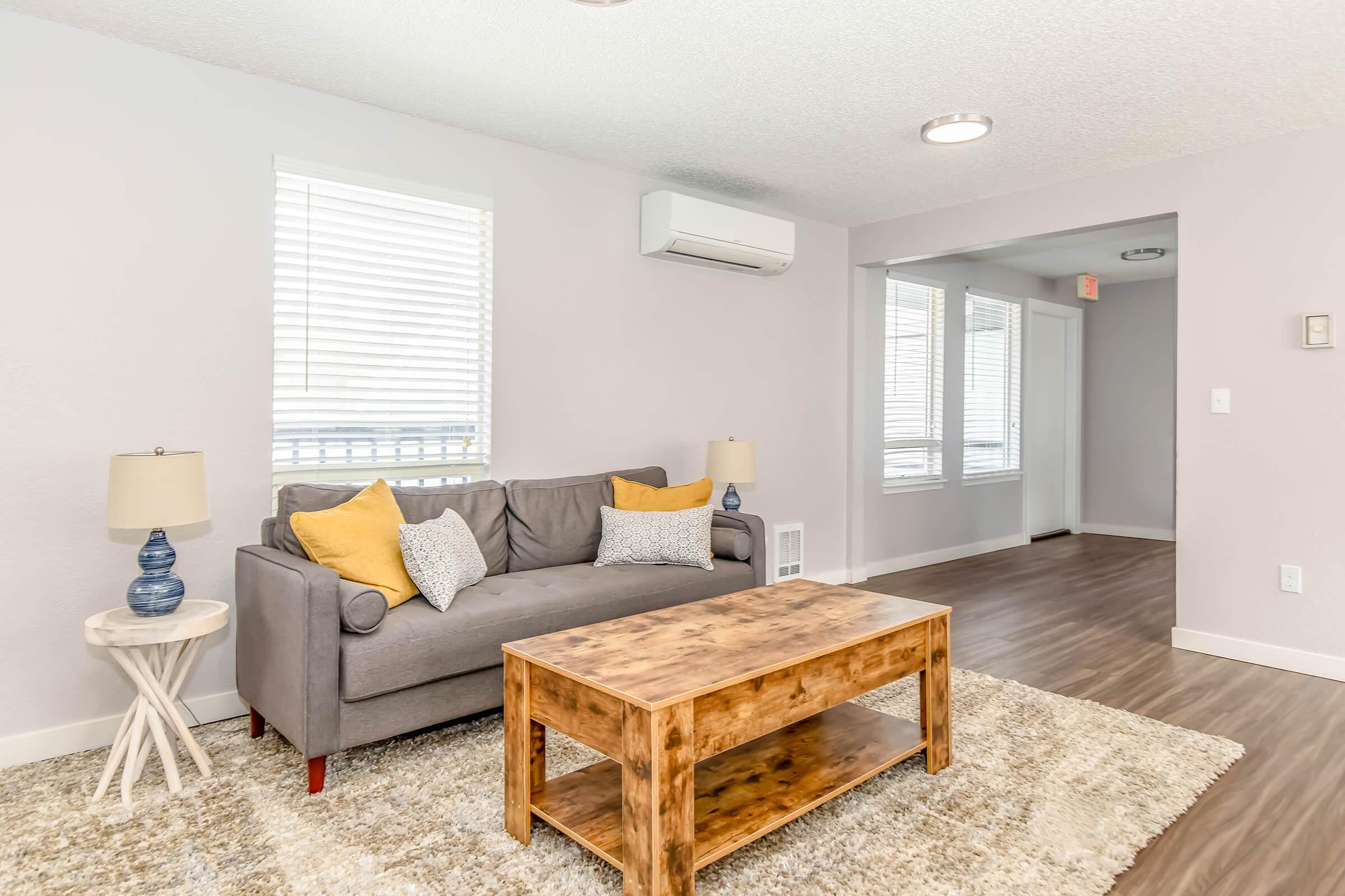 a living room filled with furniture and a flat screen tv