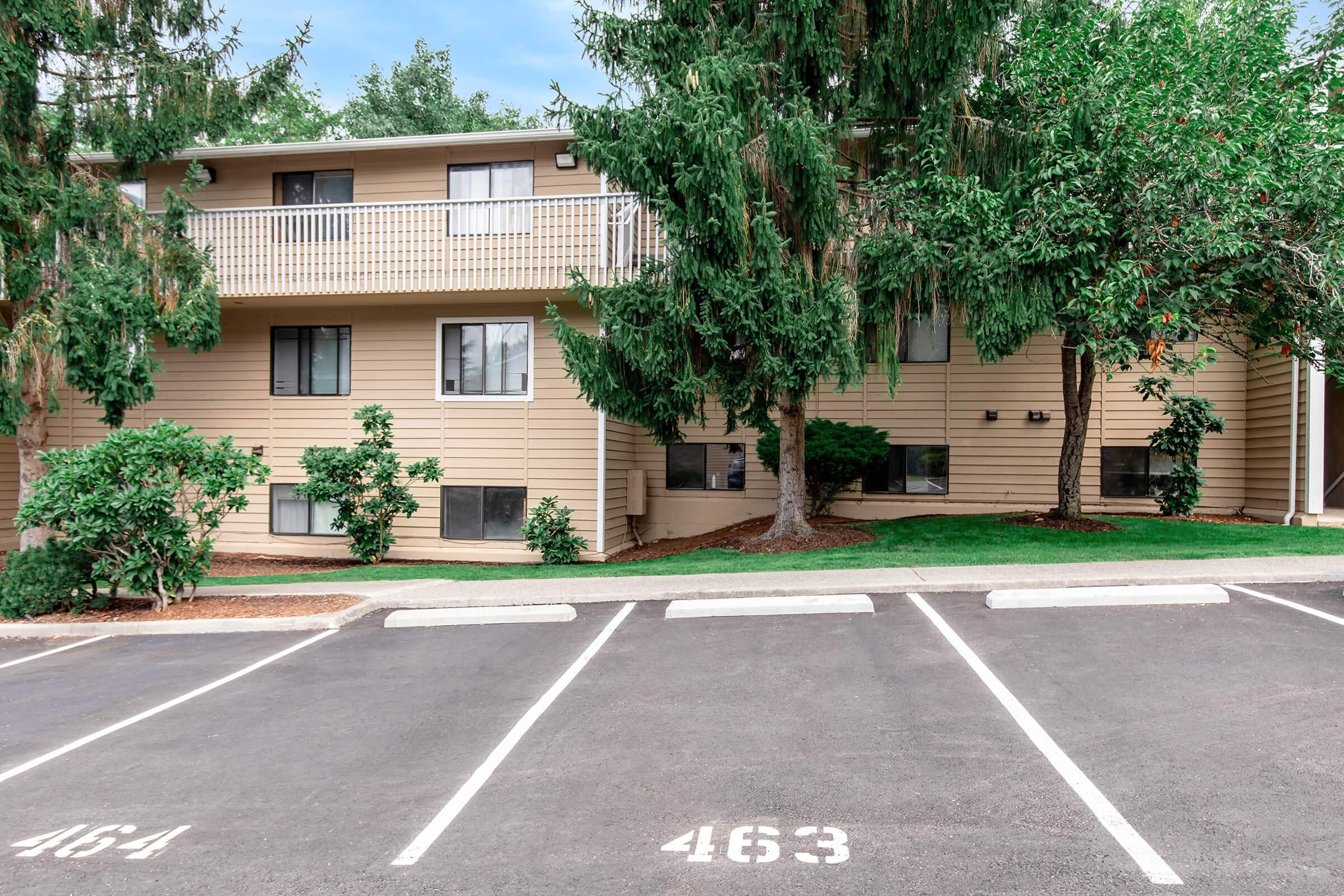 an empty parking lot in front of a building