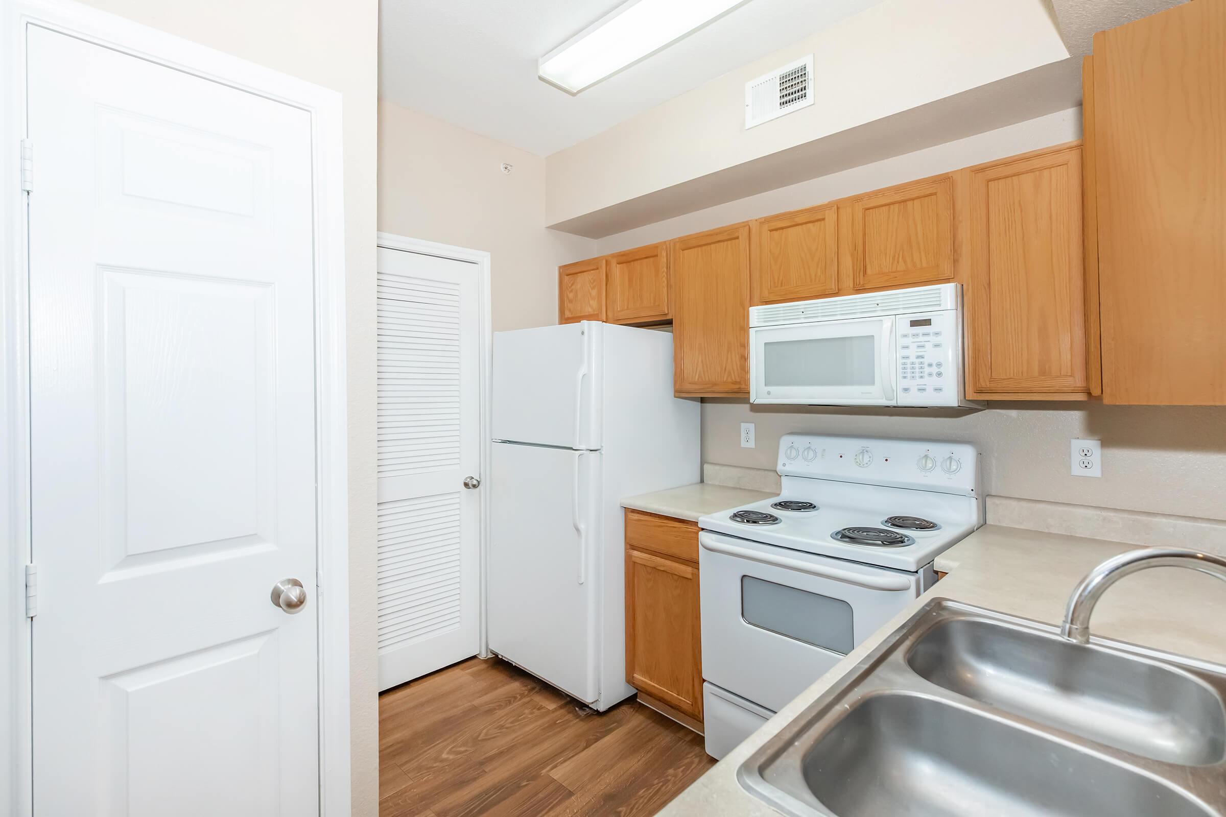 a kitchen with a stove top oven sitting inside of a refrigerator