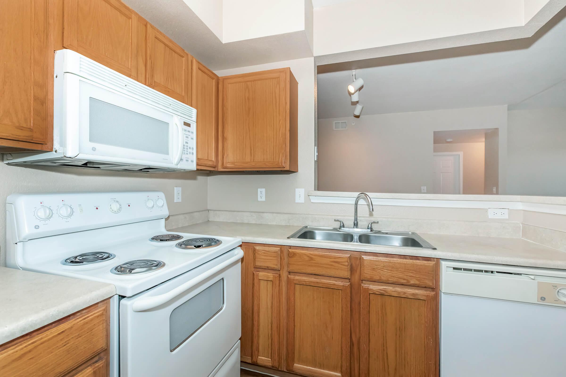 a kitchen with a stove a sink and a microwave