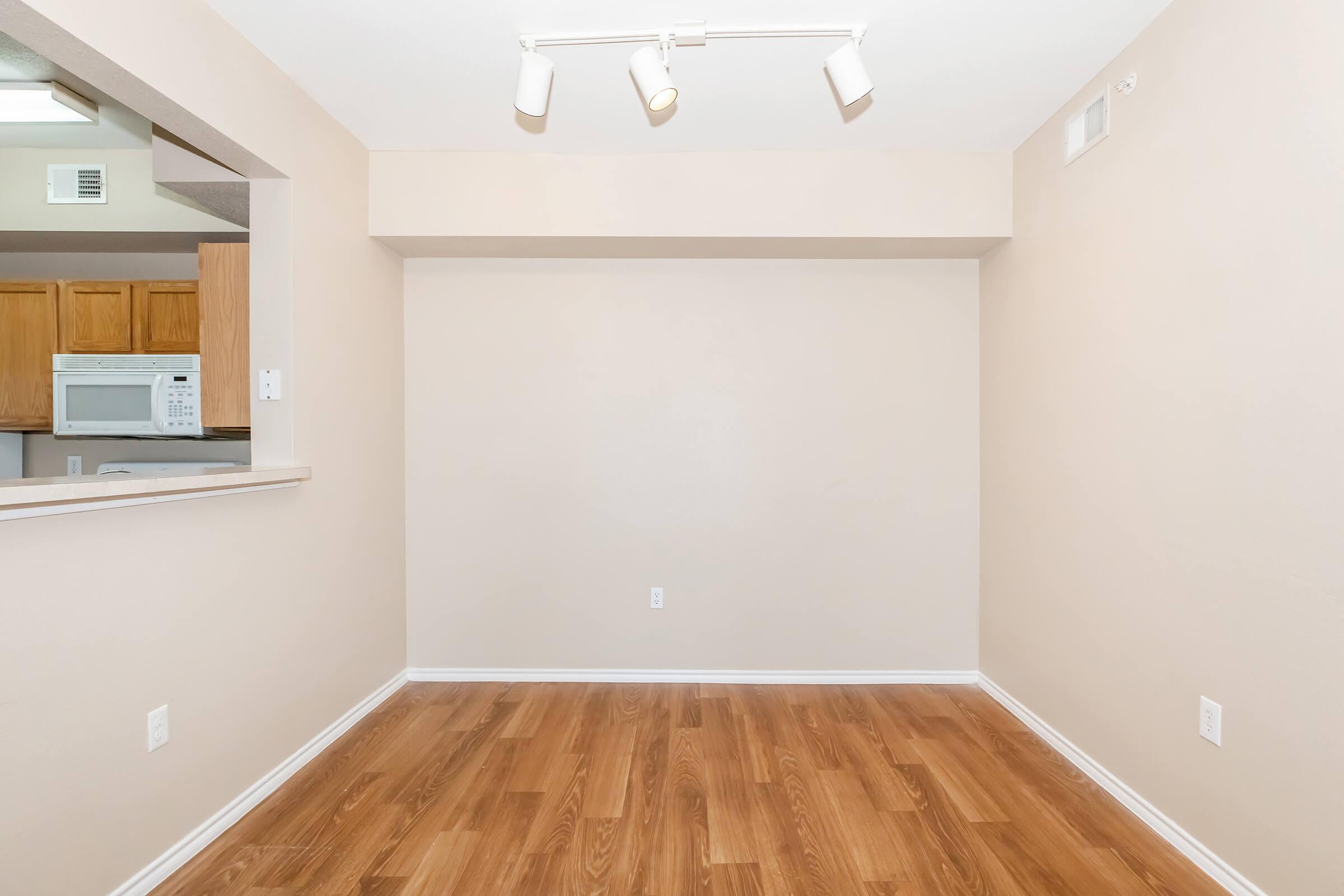 a large empty room with a wood floor