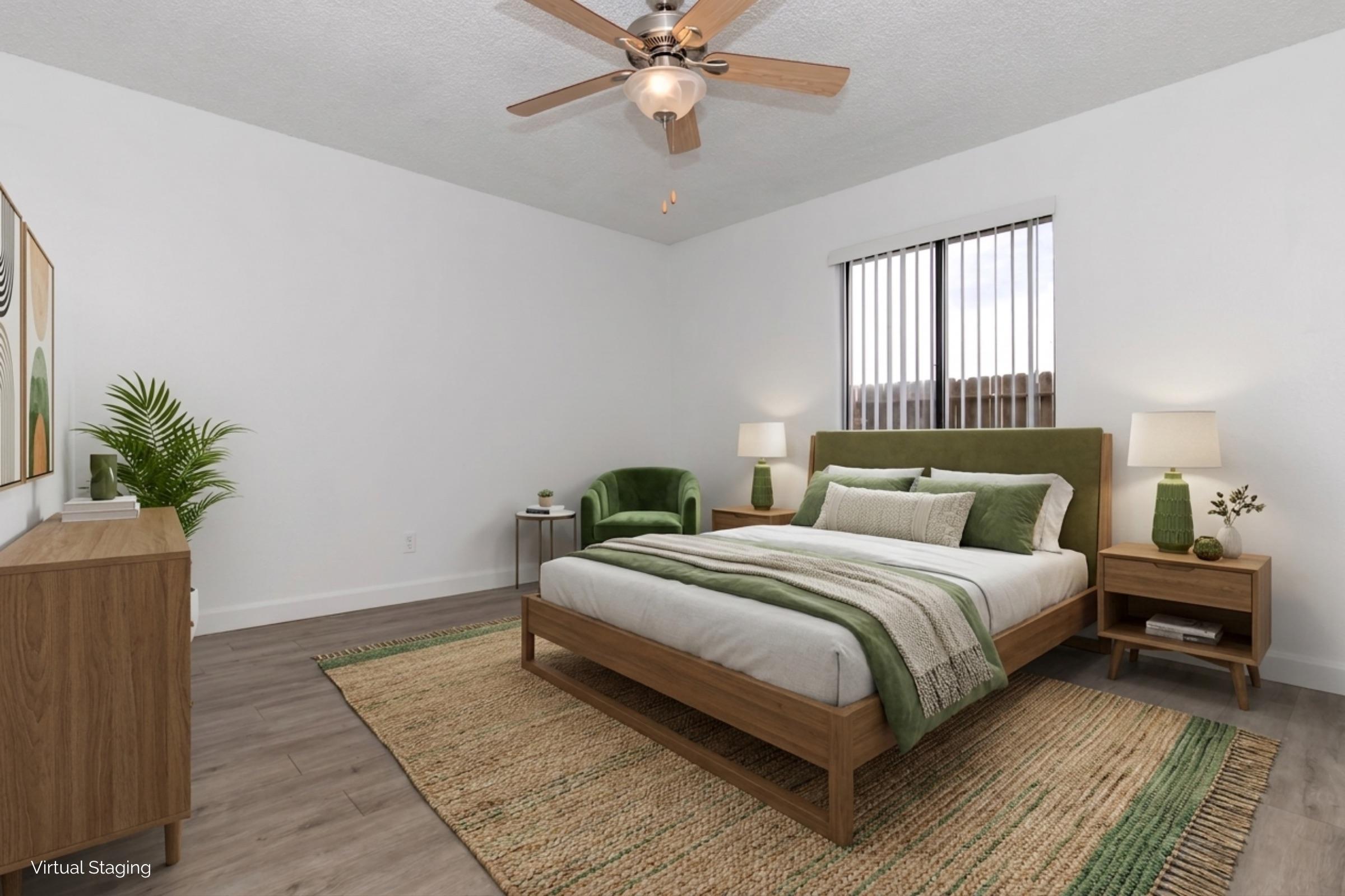 A modern bedroom featuring a wooden bed with green and white bedding, two bedside tables with lamps, a cozy green armchair, and a large window with vertical blinds. A stylish area rug and a potted plant add to the decor, creating a bright and inviting atmosphere.