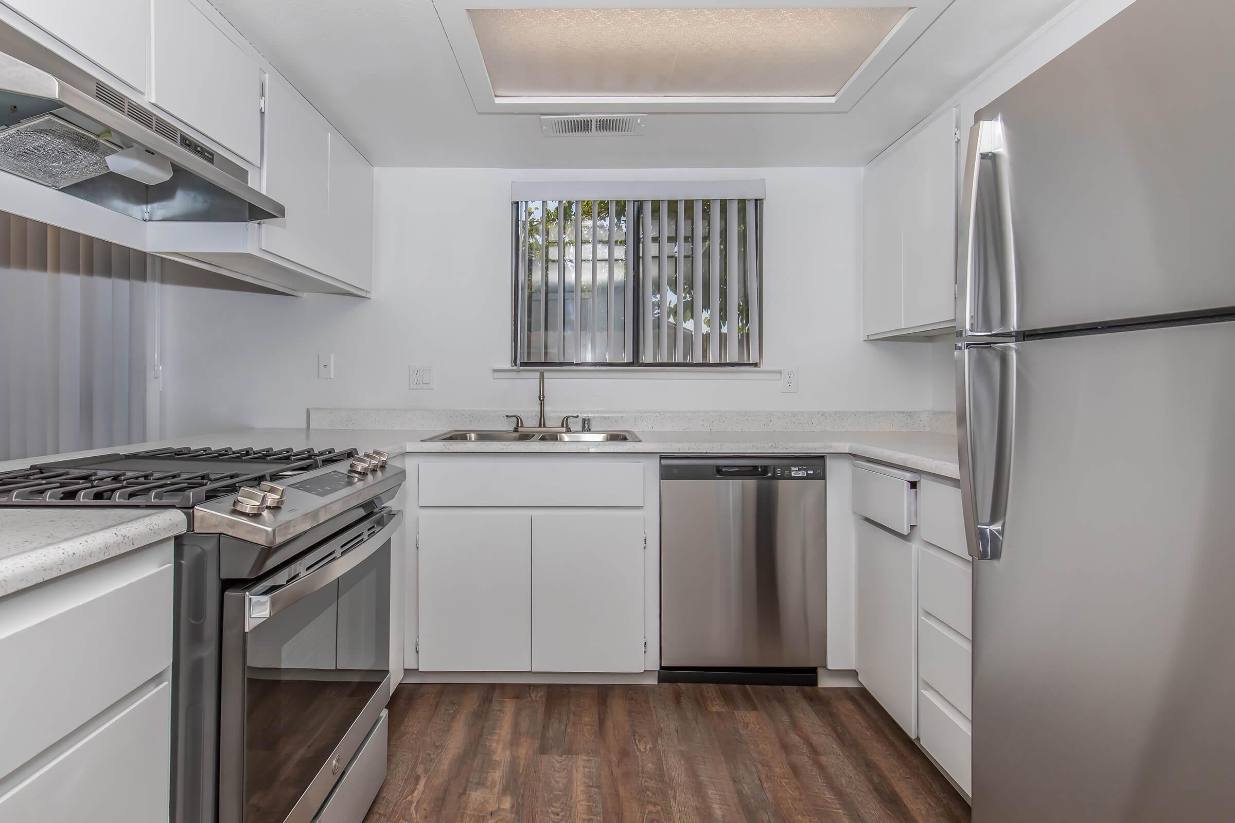 a kitchen with a stove sink and refrigerator