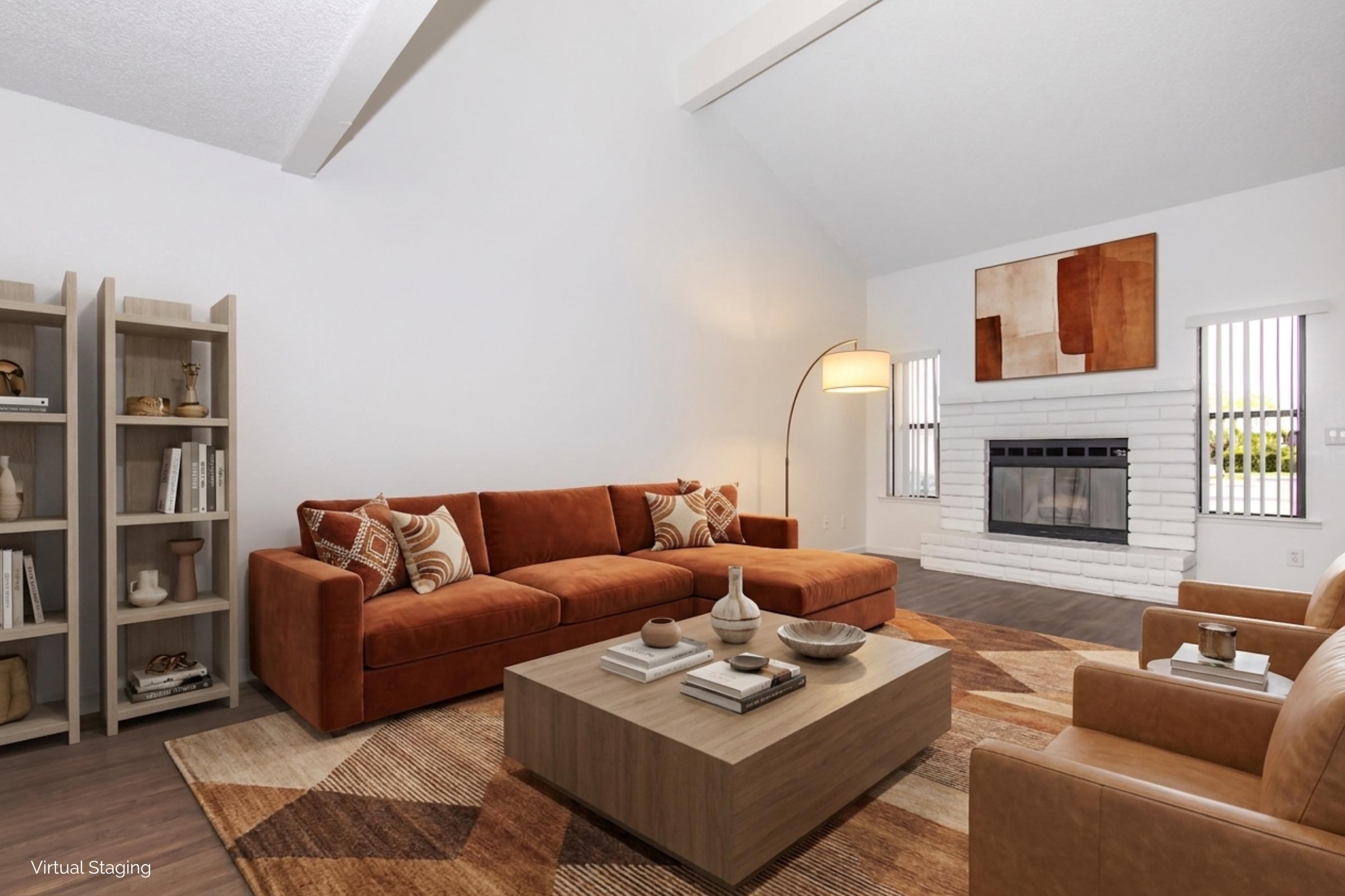 A stylish living room featuring a brown sectional sofa, two tan armchairs, a rectangular coffee table, and decorative accents. The walls are painted white with large windows and a fireplace, while a patterned area rug adds warmth to the space. A modern floor lamp and wall art complete the decor.
