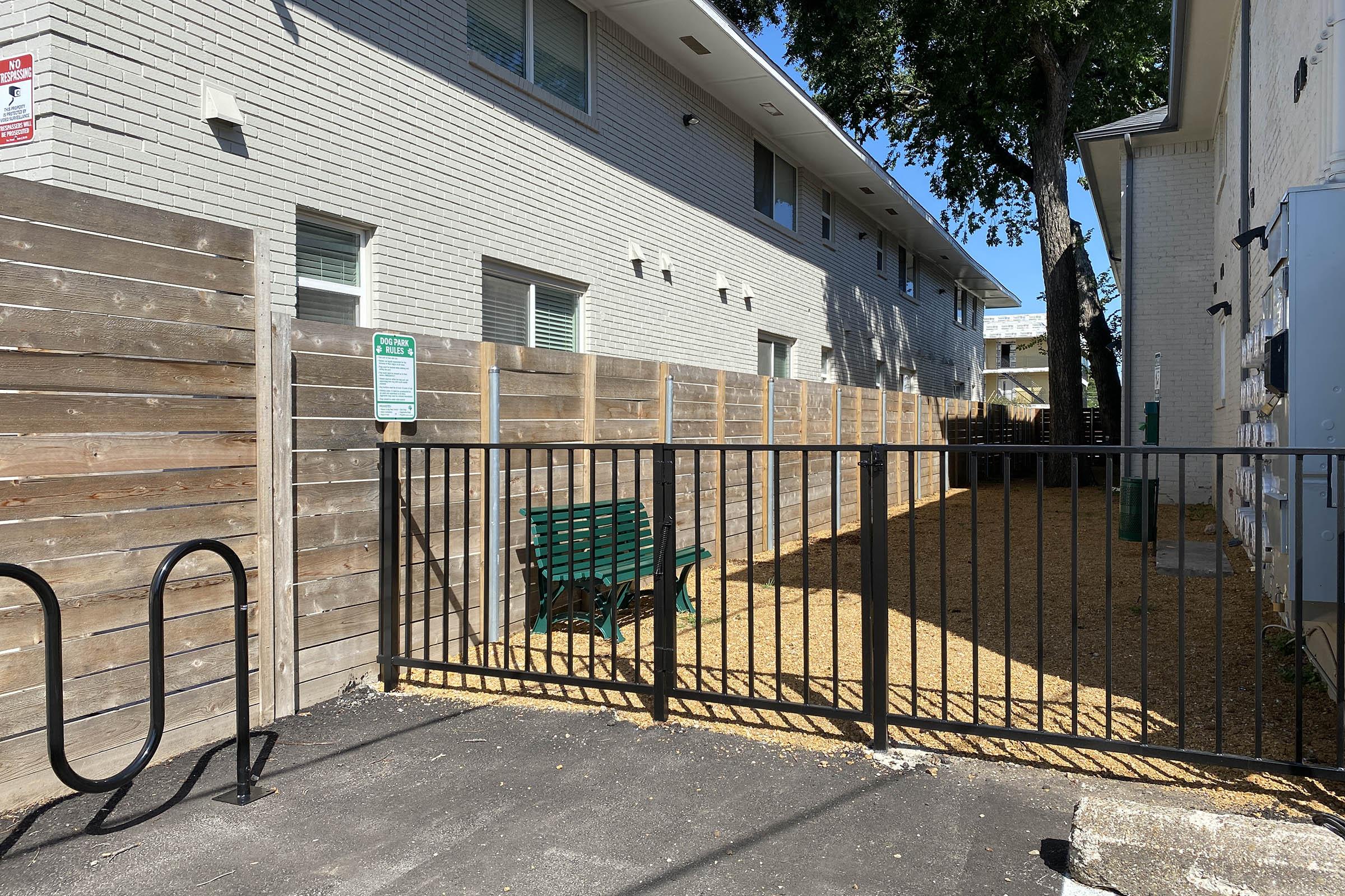 a bike rack next to the pet park