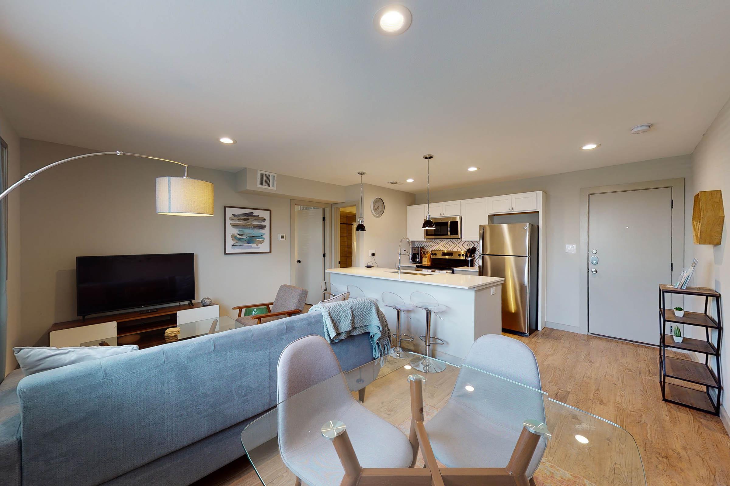 a furnished apartment with white cabinets