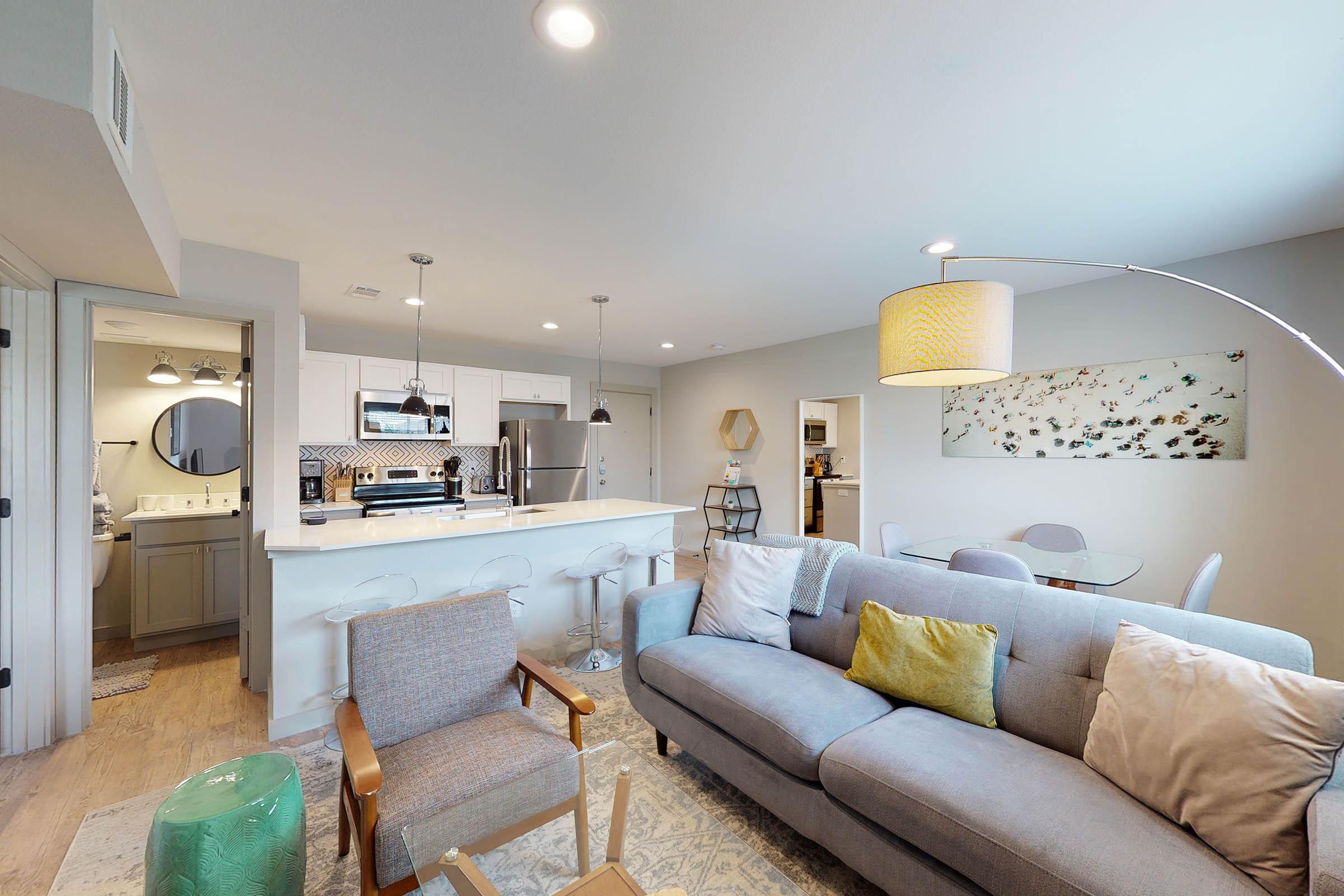 a furnished living room with a tan couch