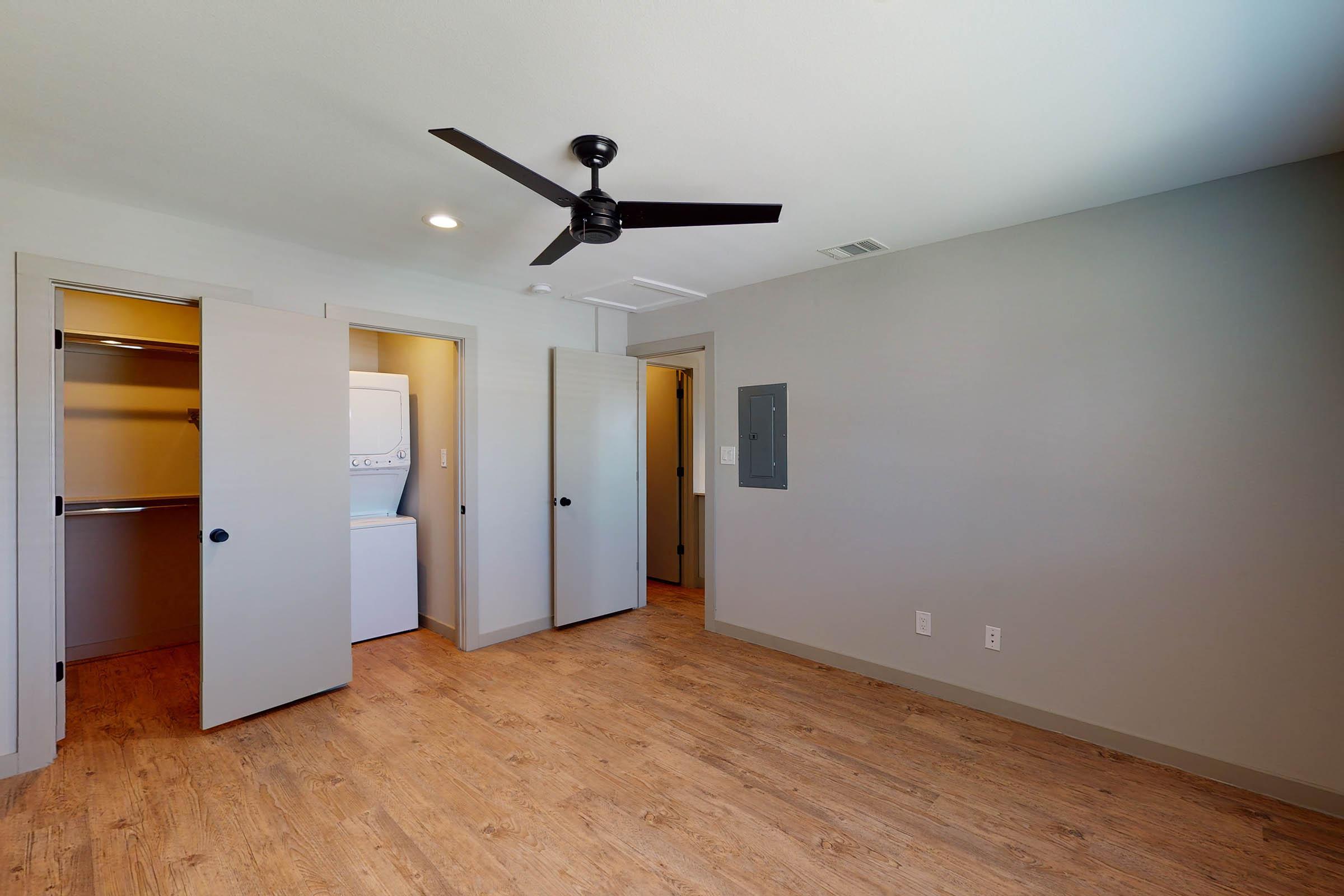 bedroom with a stacked washer and dryer