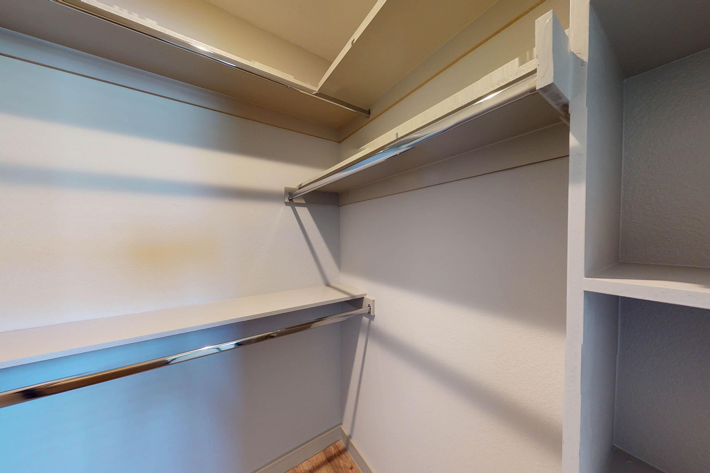 walk-in closet with wooden floors