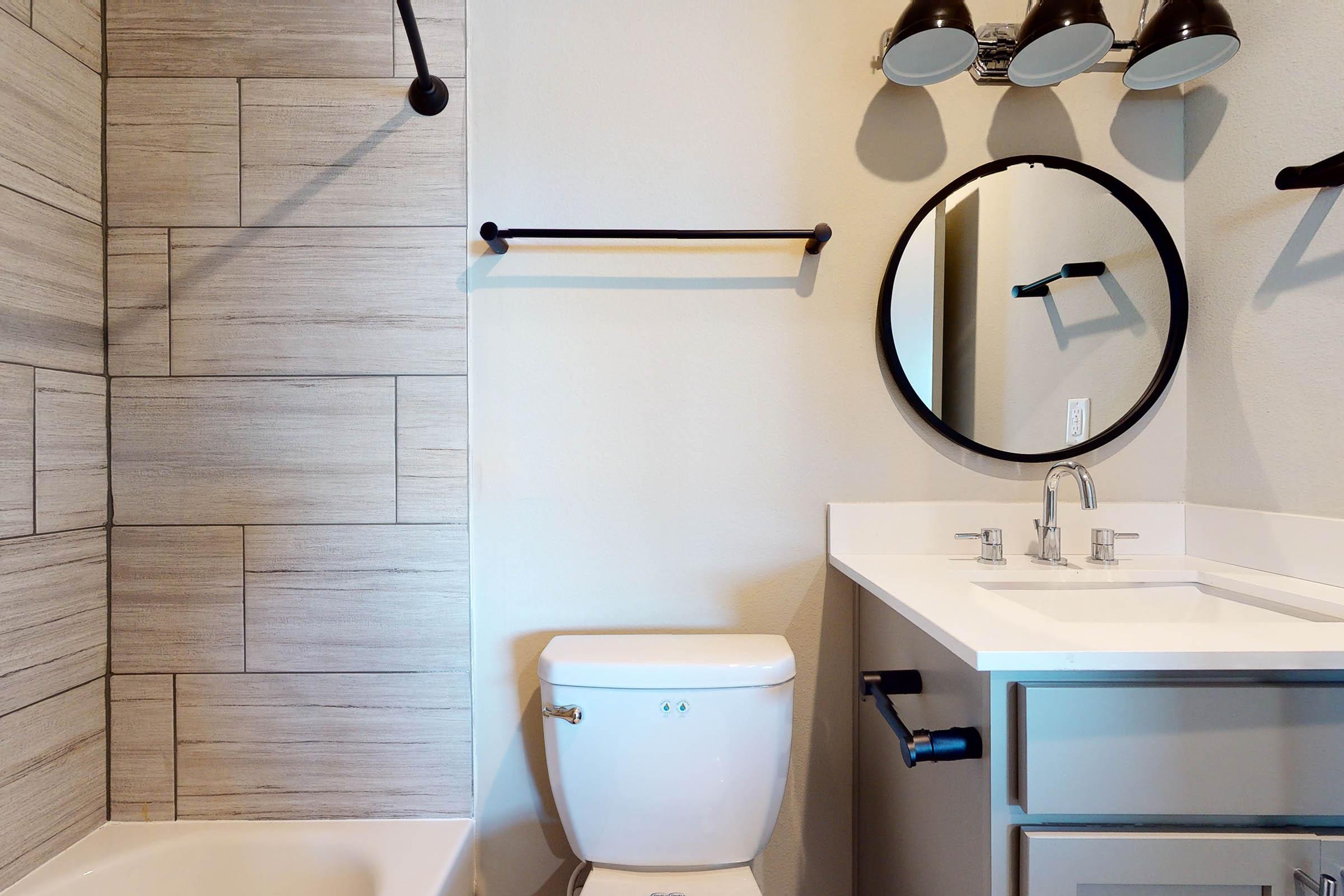 bathroom with a circle mirror