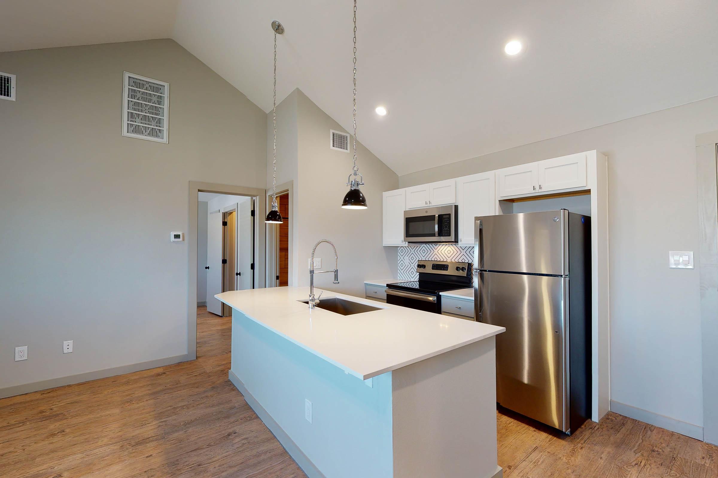 kitchen and bedroom with wooden floors