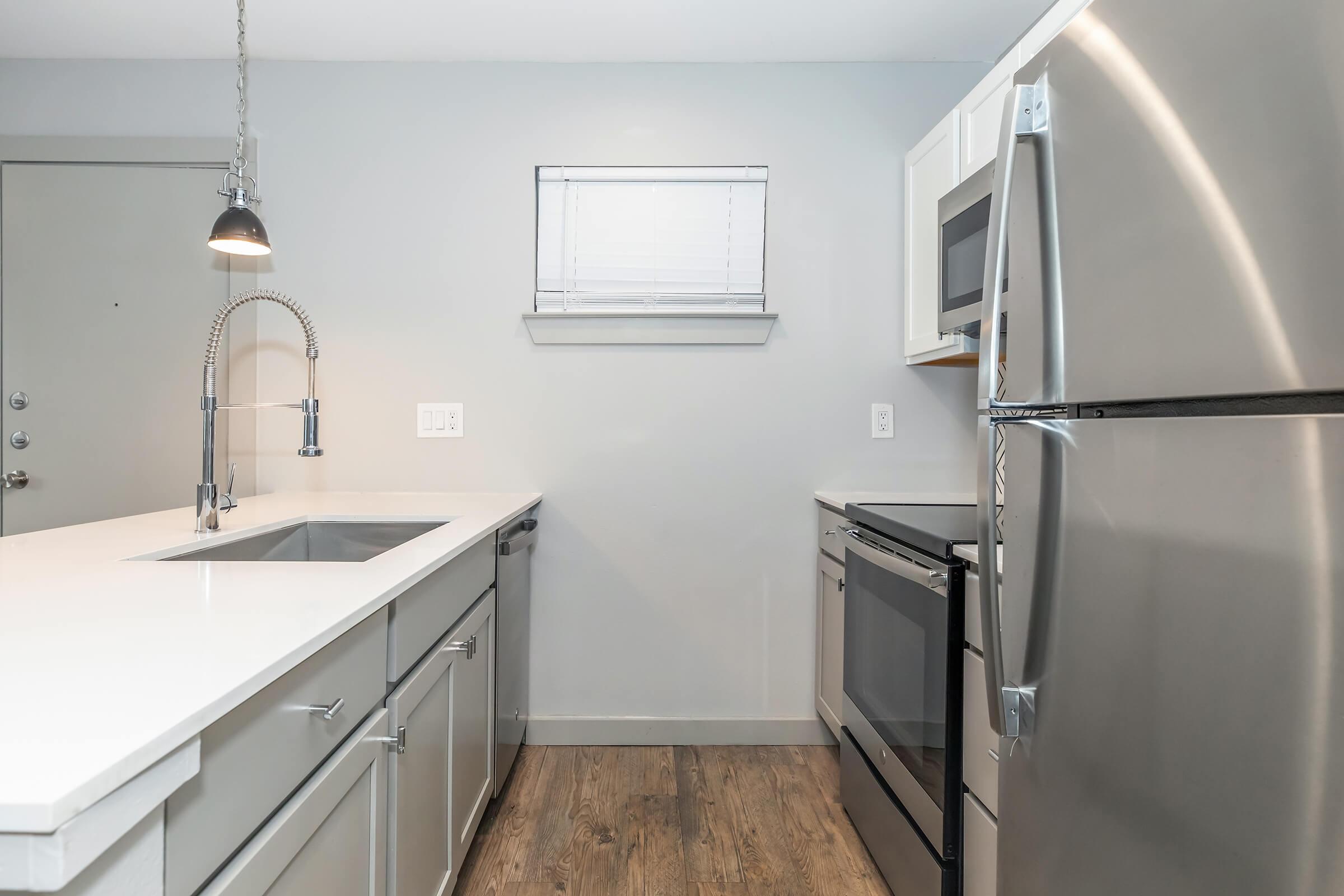 a kitchen with a sink and a refrigerator