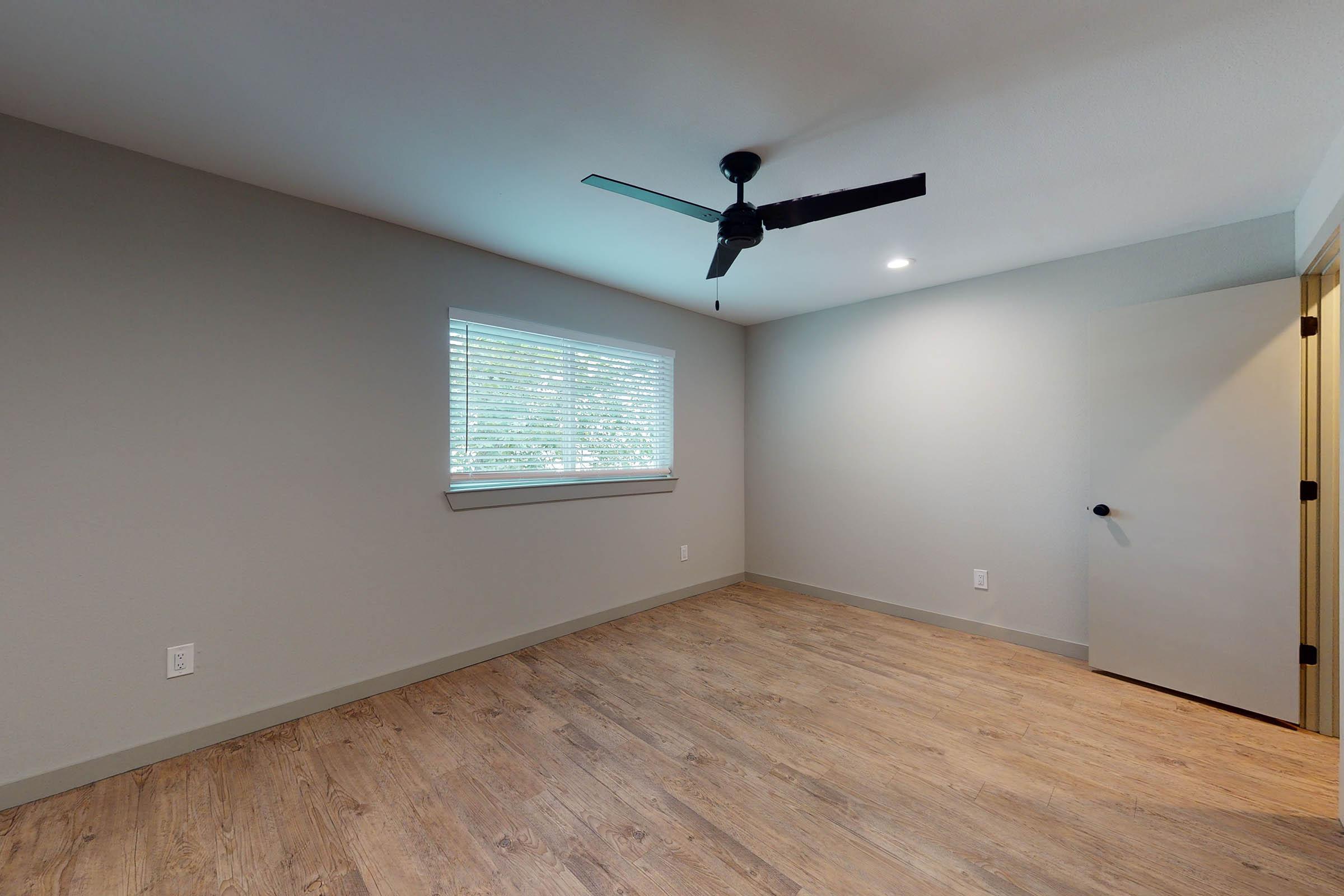 a loft with a ceiling fan