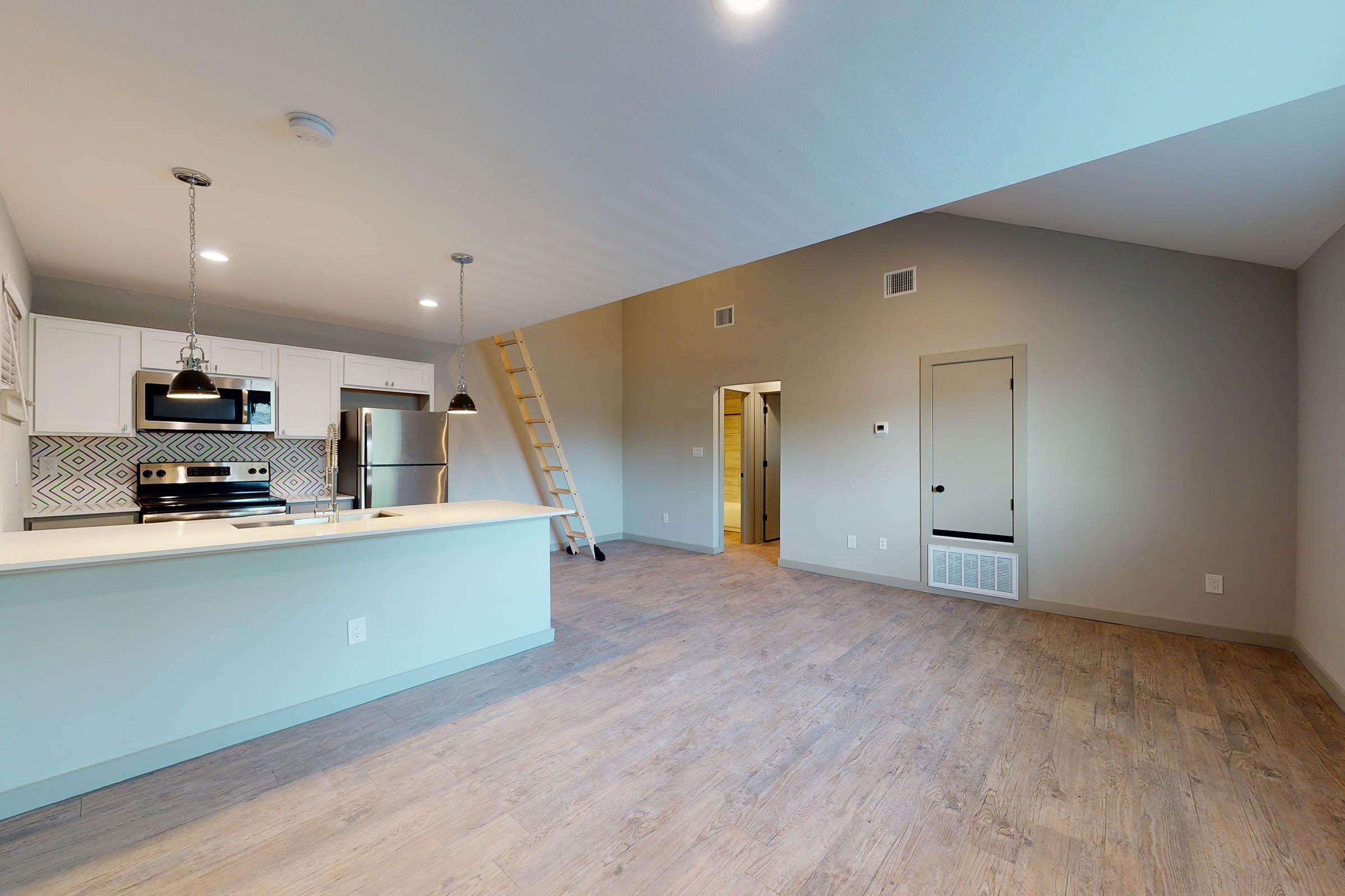 a living room and dining room with stairs