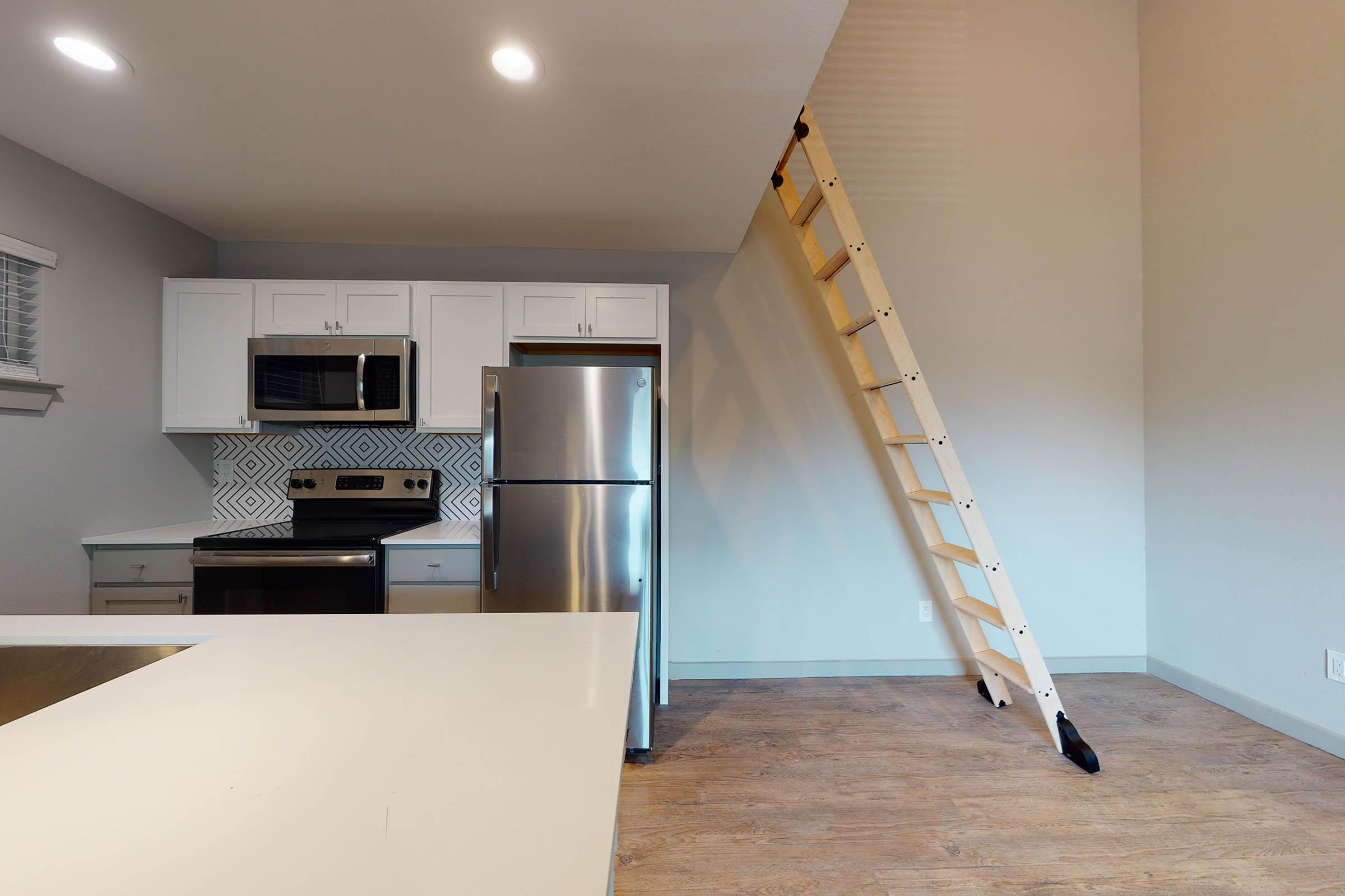 a kitchen and dining room with stairs