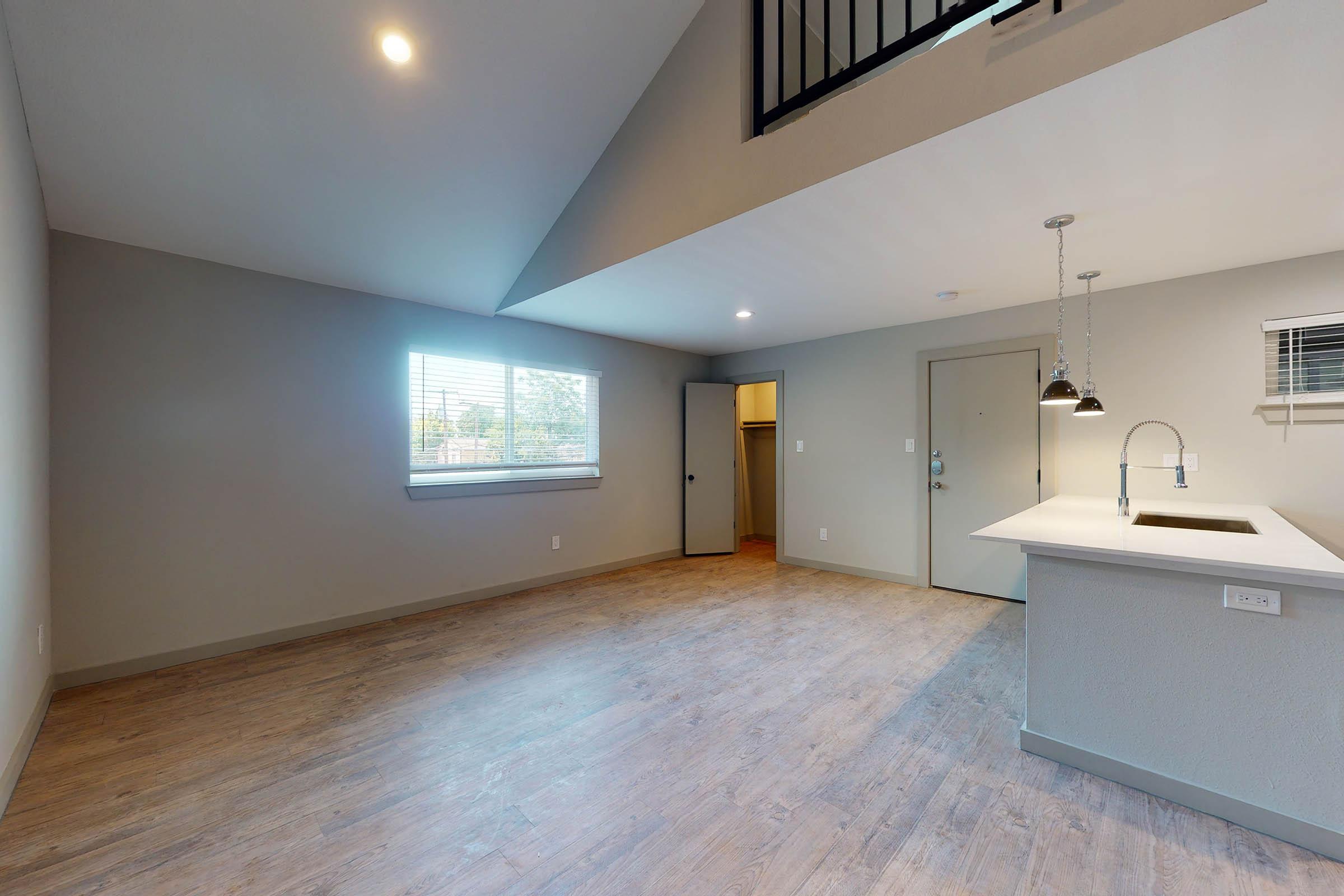 a living room and dining room with wooden floors