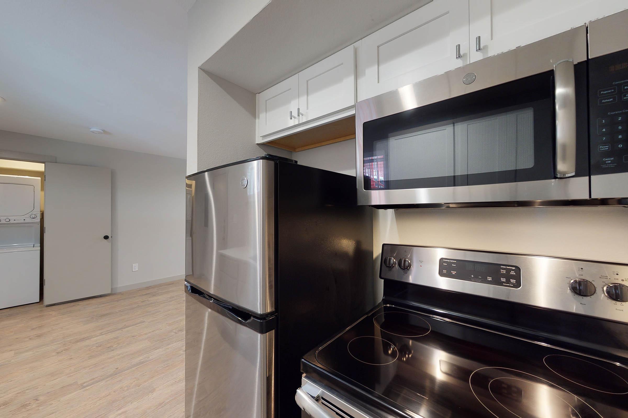 an unfurnished kitchen with stainless steel appliances