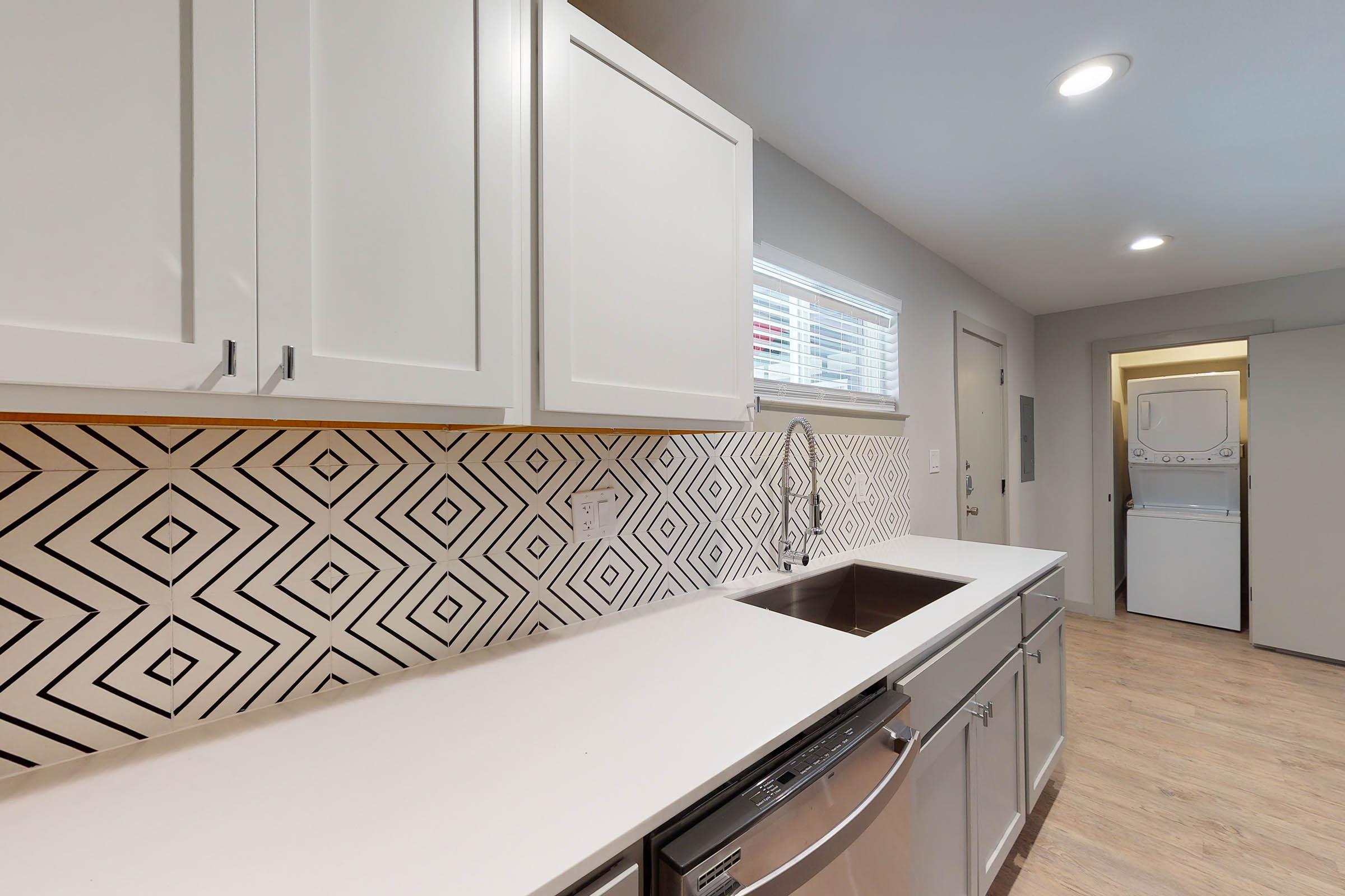 an unfurnished kitchen with a backsplash