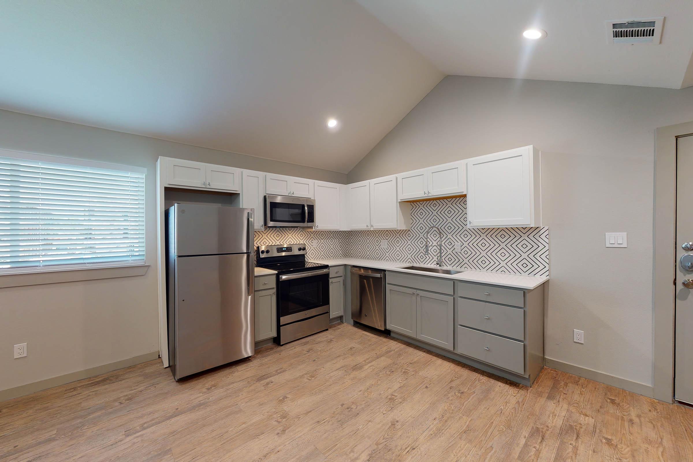 a vacant apartment with wooden cabinets