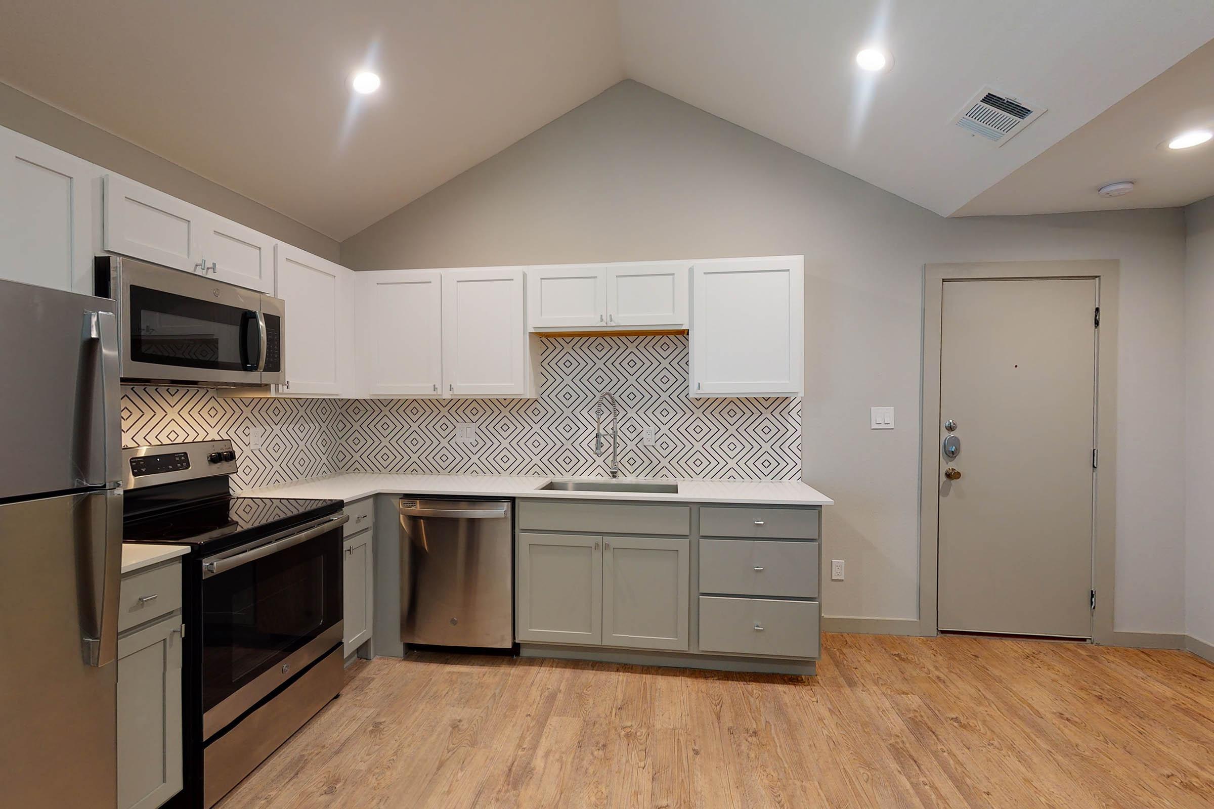 a vacant kitchen with stainless steel appliances