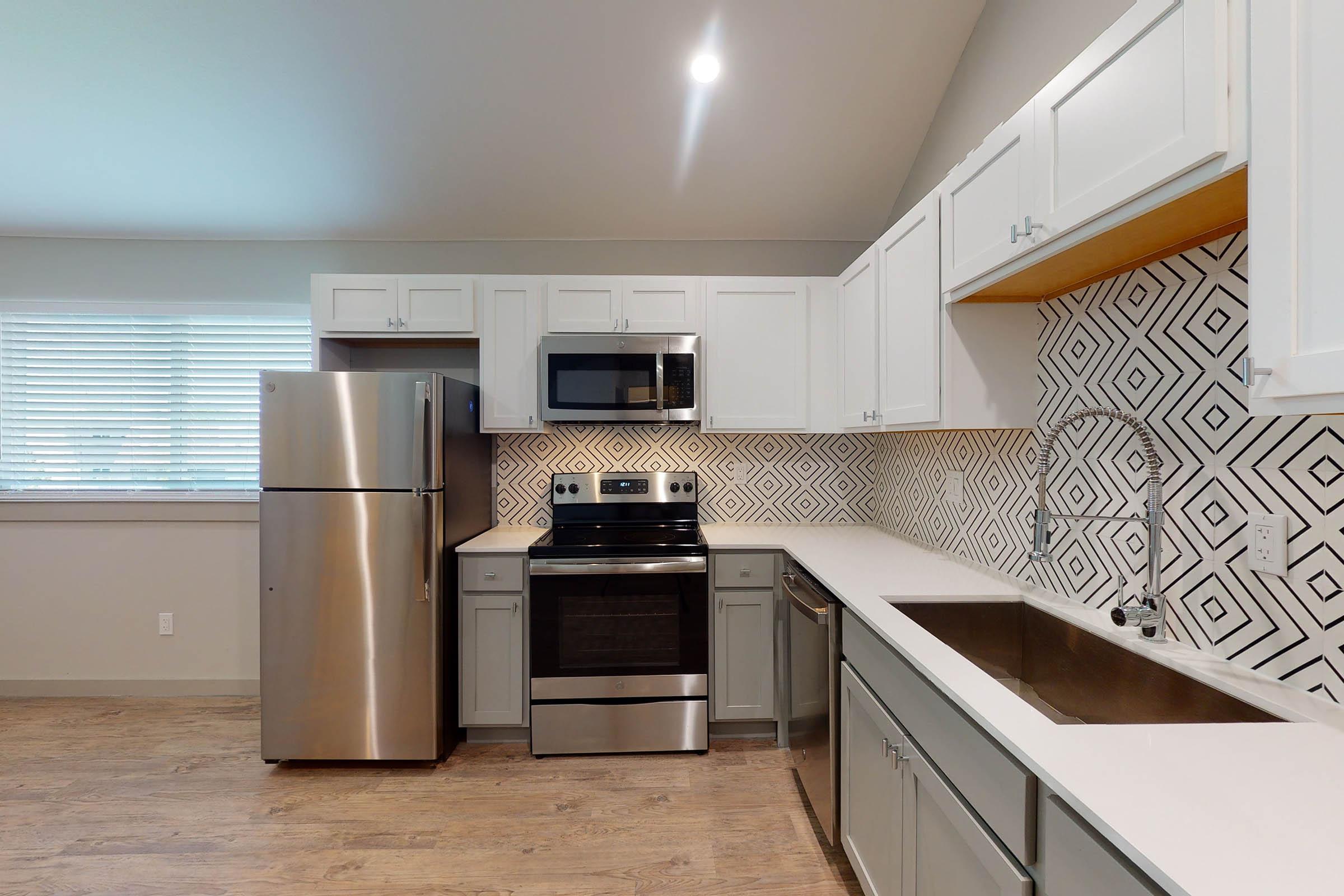 a vacant kitchen with wooden cabinets