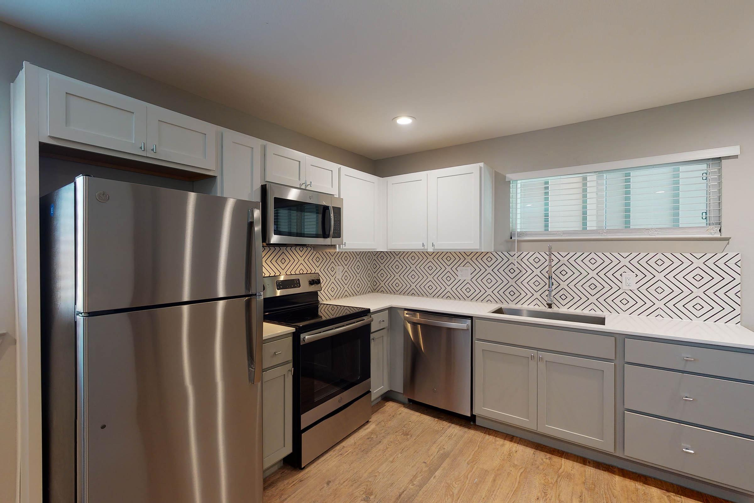 vacant kitchen with wooden cabinets