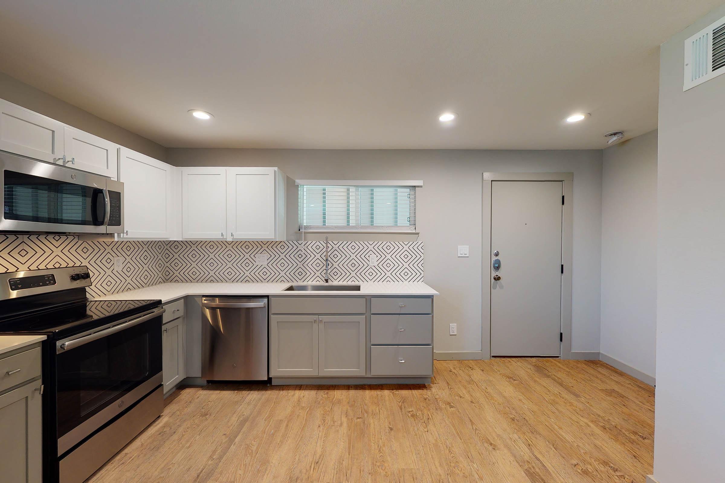 vacant kitchen with wooden floors