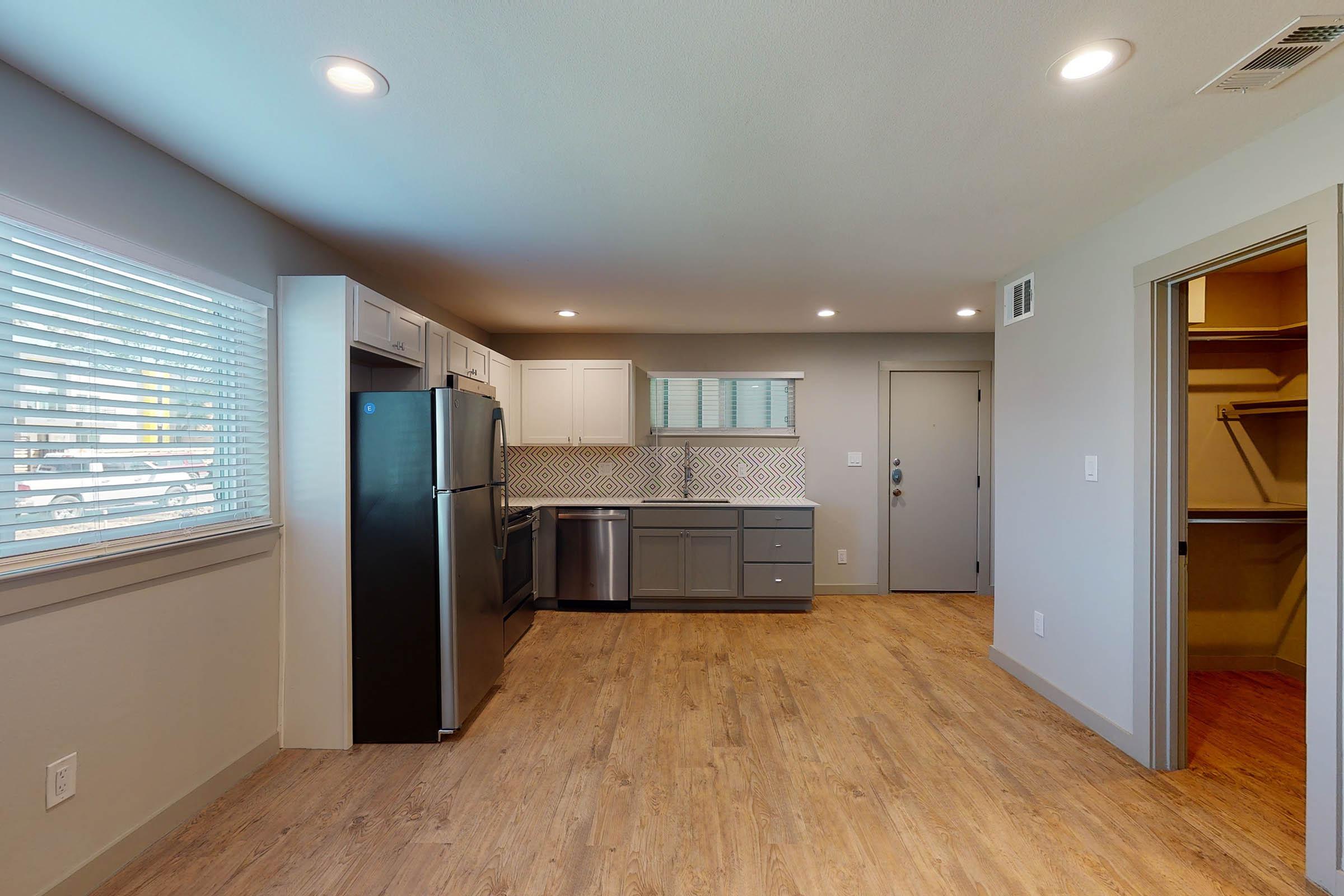 vacant apartment and closet with wooden floors