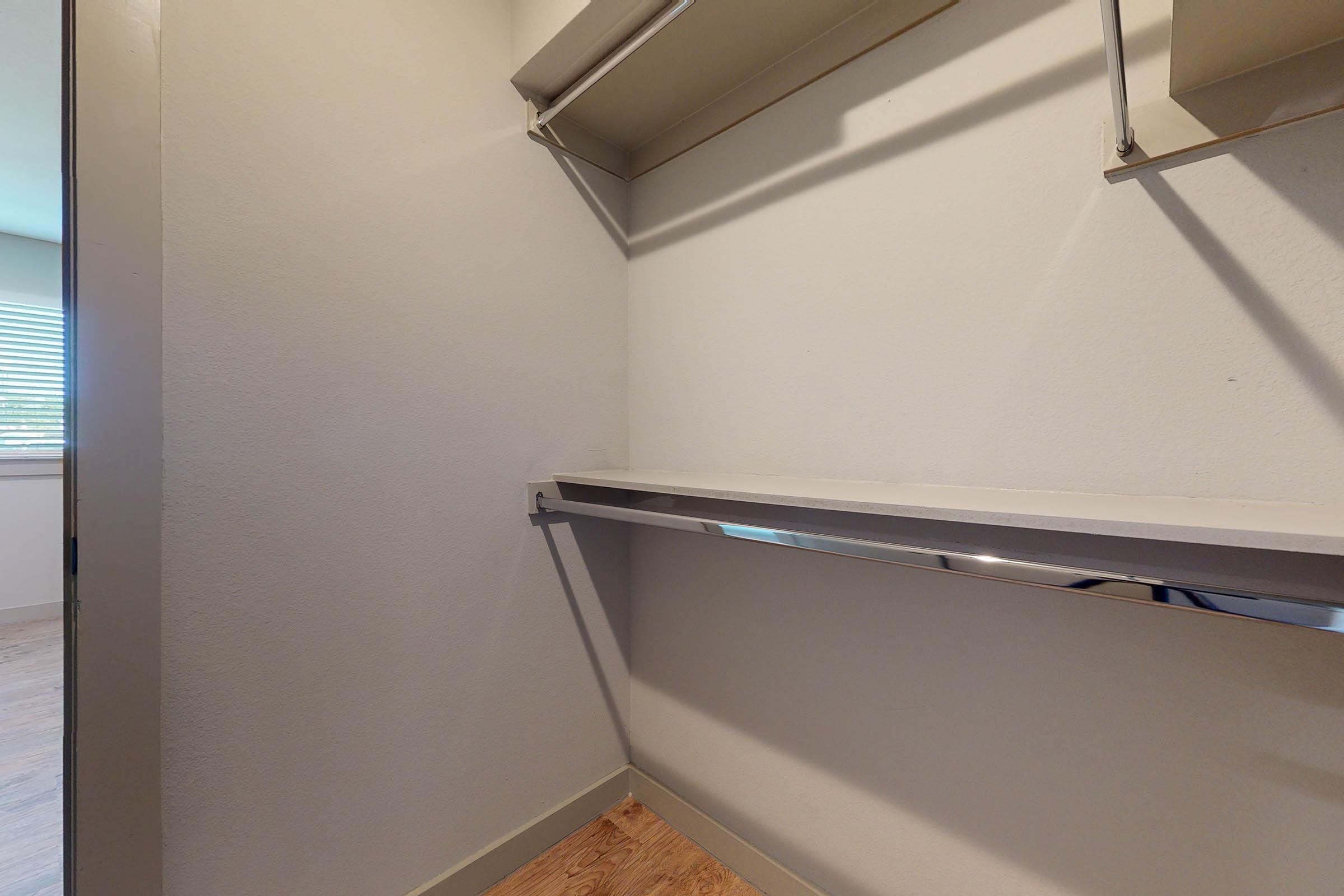 vacant walk-in closet with wooden floors