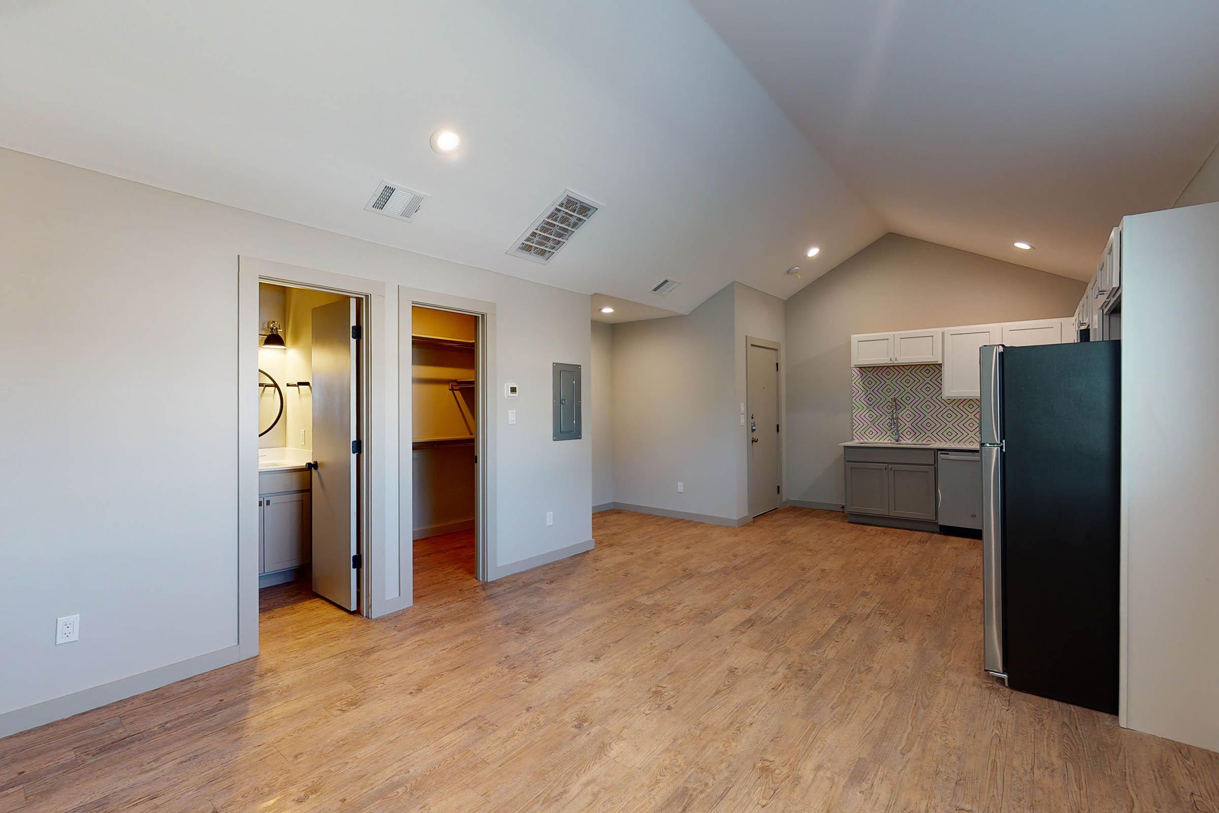 bathroom and closet with wooden floors