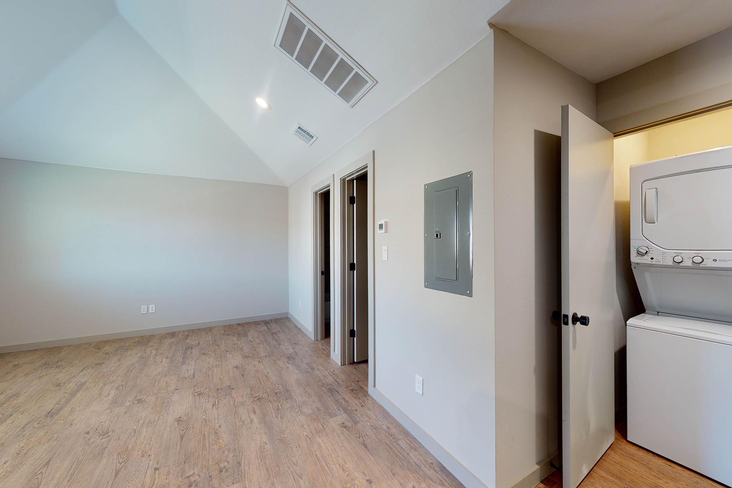 living room with stacked washer and dryer