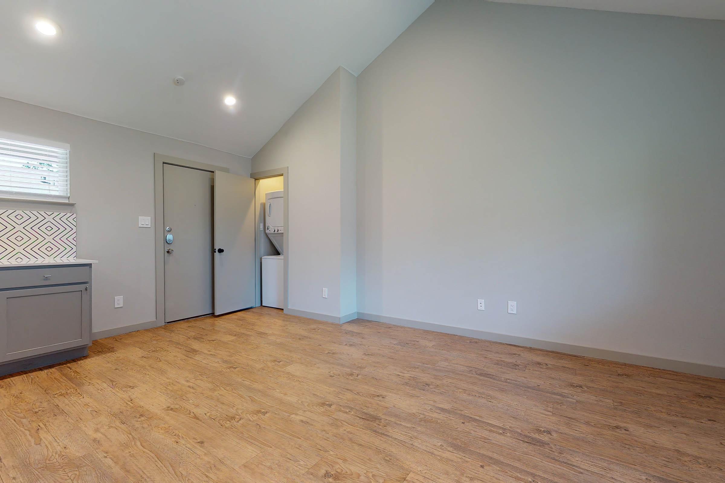 apartment with open door to stacked washer and dryer