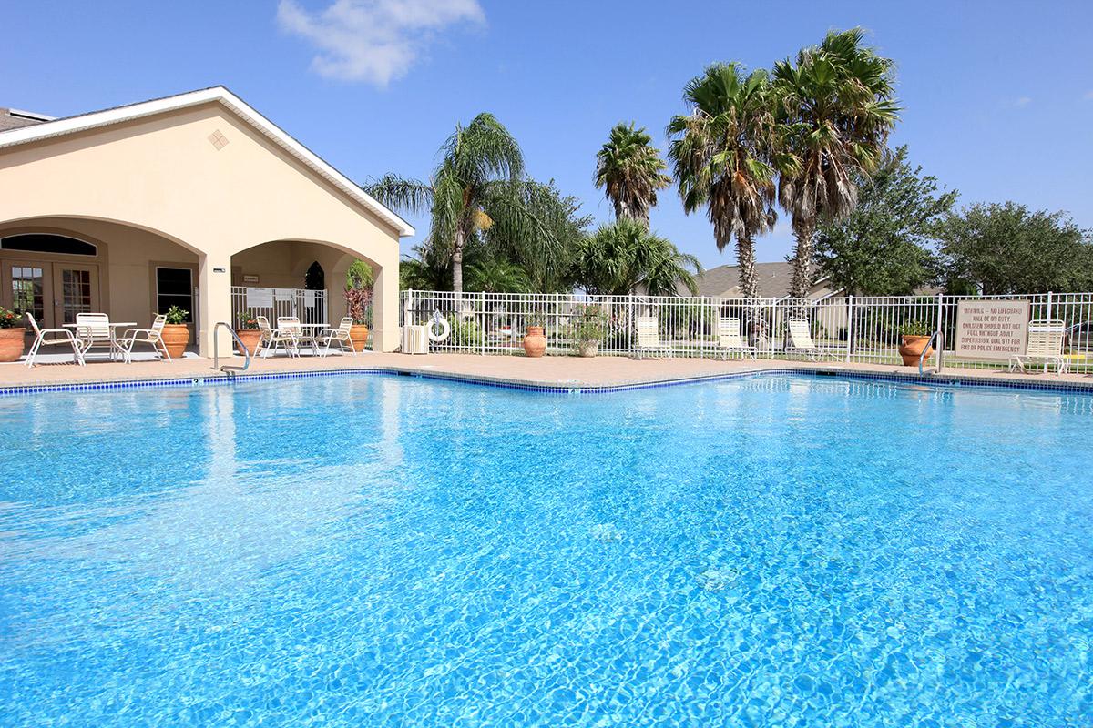 a blue pool of water in front of a house