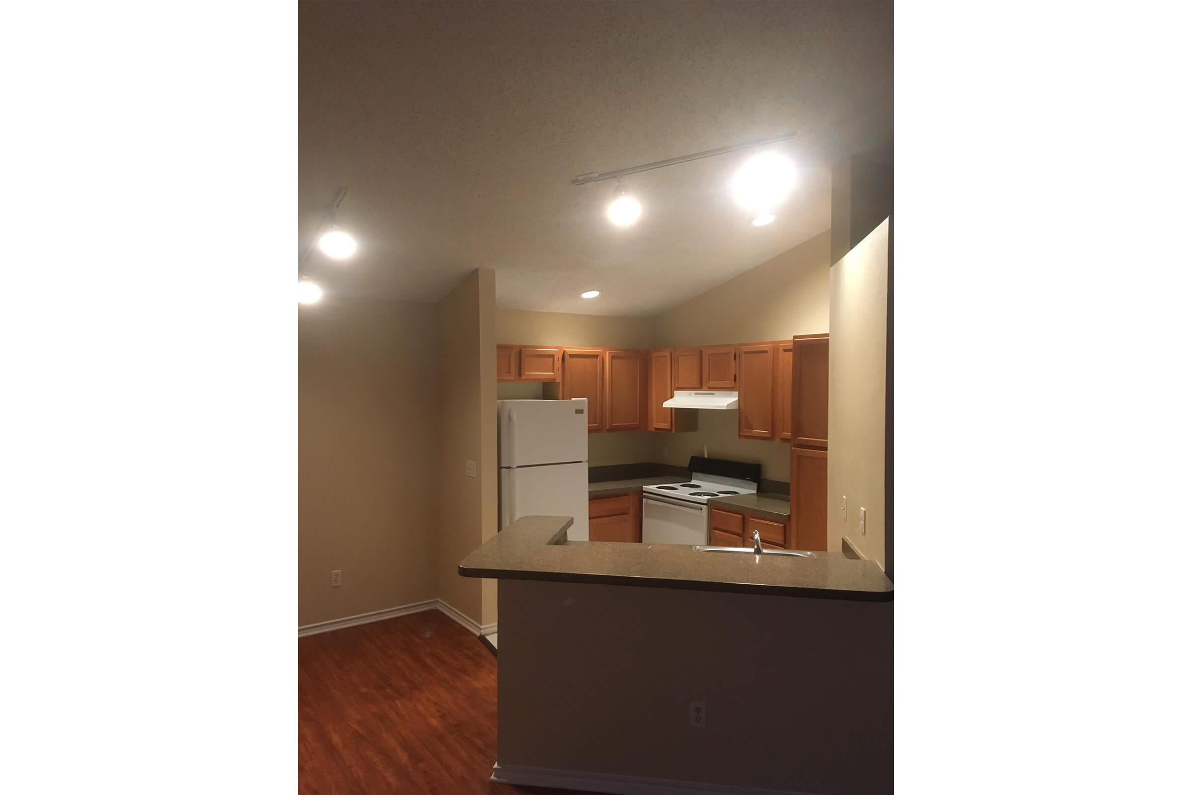 a kitchen with wooden cabinets