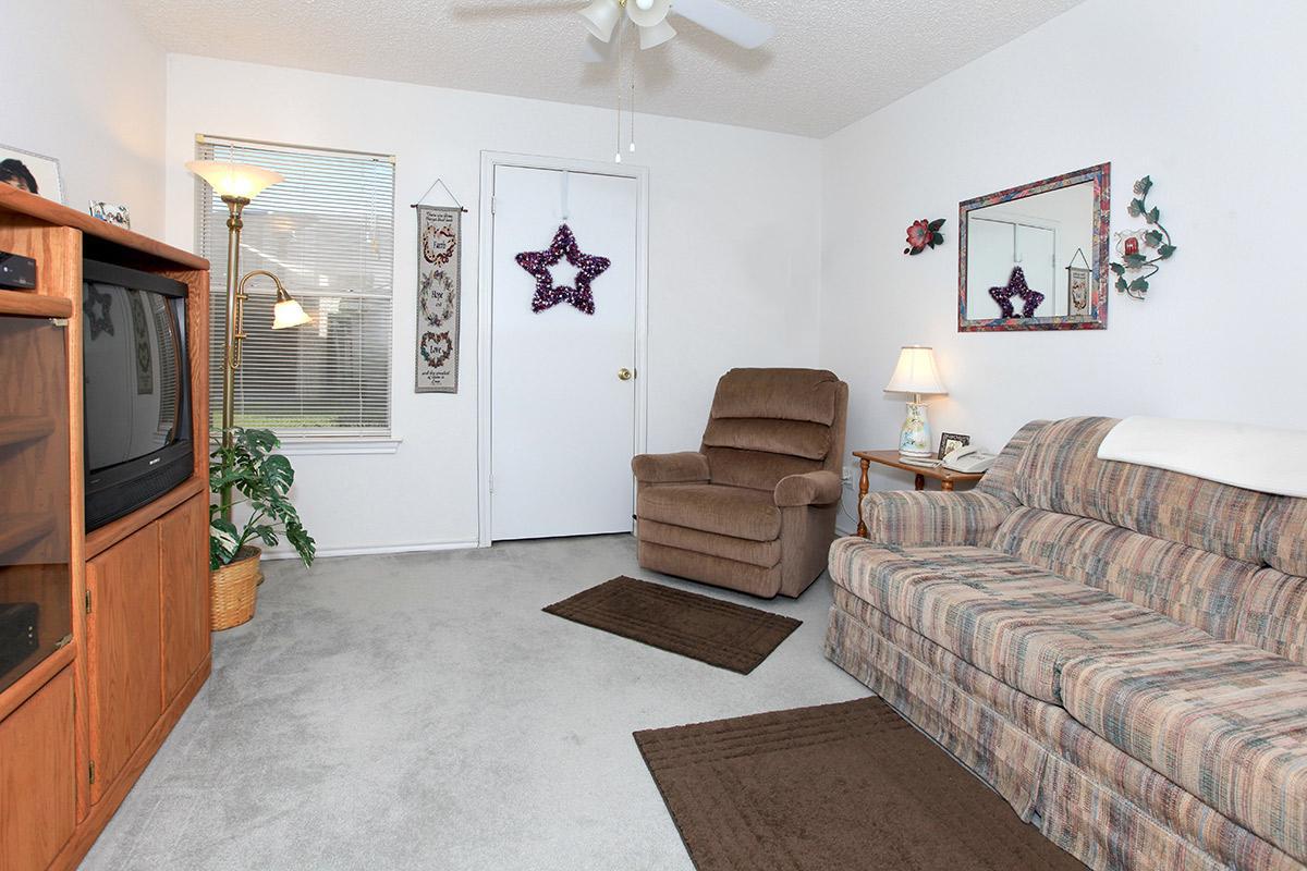 a living room filled with furniture and a flat screen tv