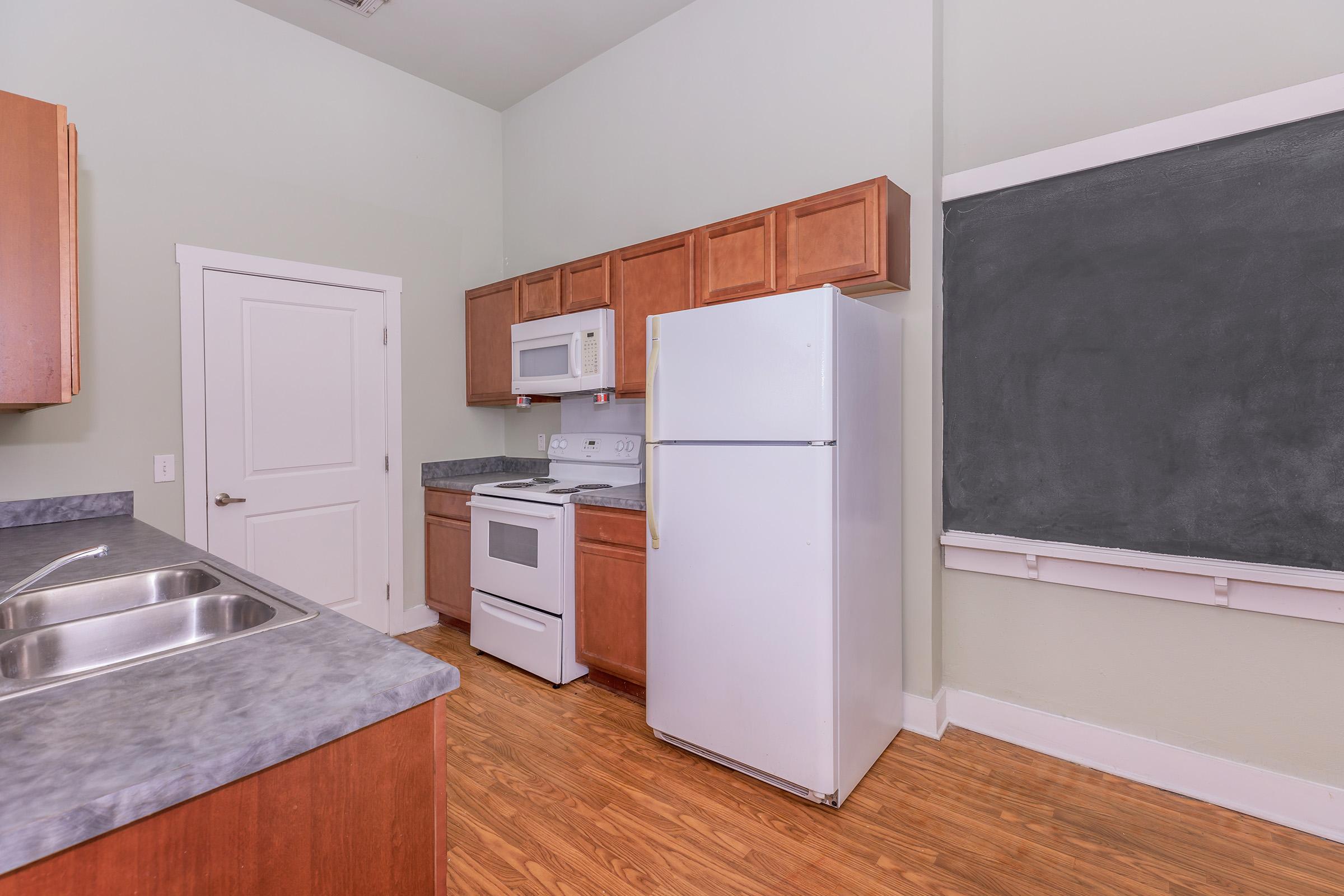 a kitchen with a sink and a refrigerator