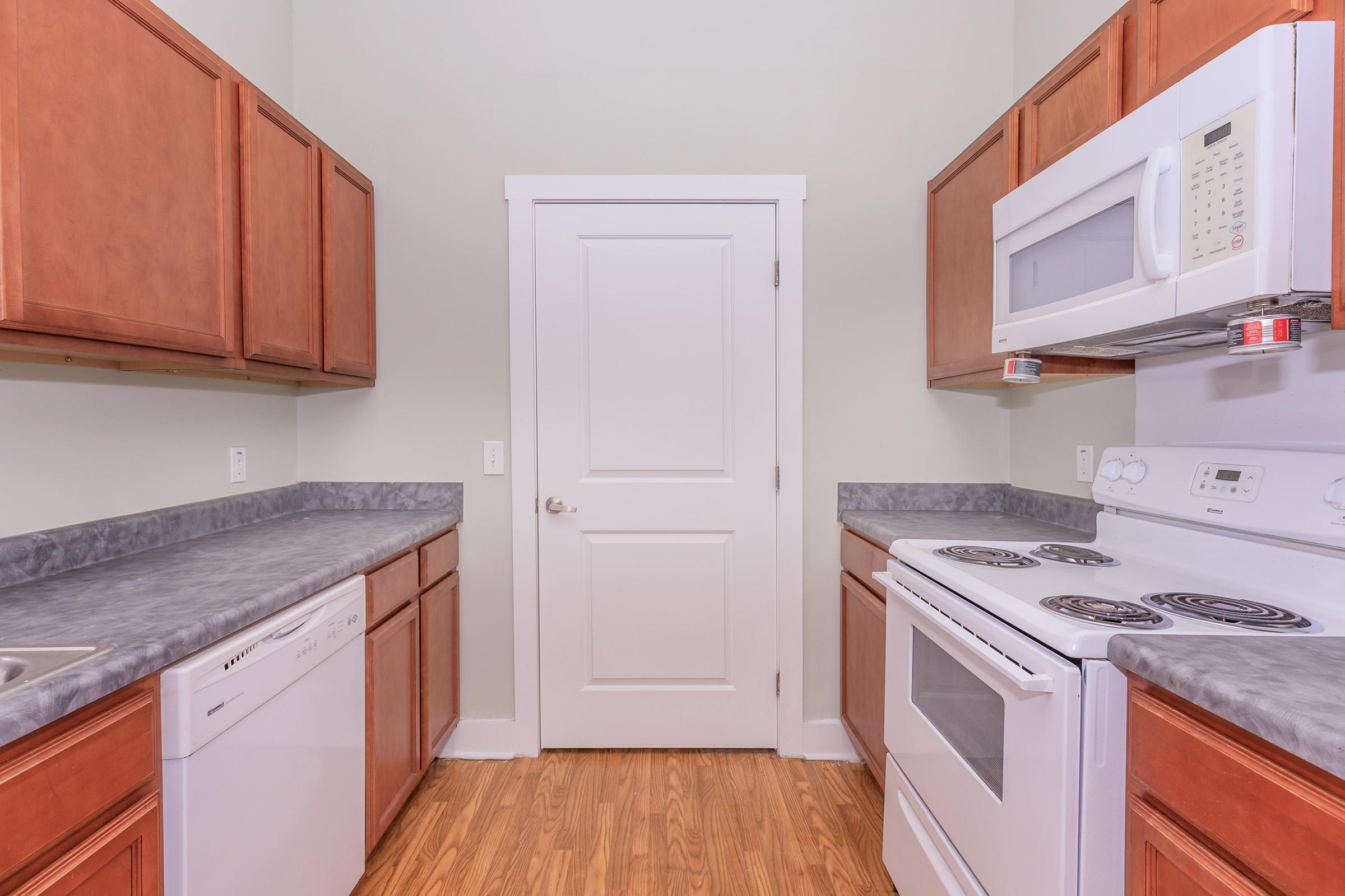 a kitchen with a refrigerator stove and microwave