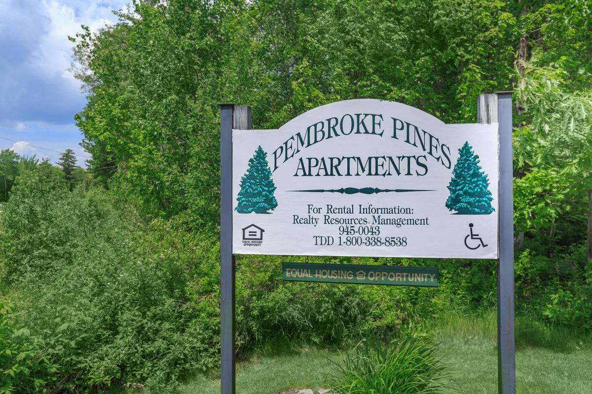 a sign in front of a tree